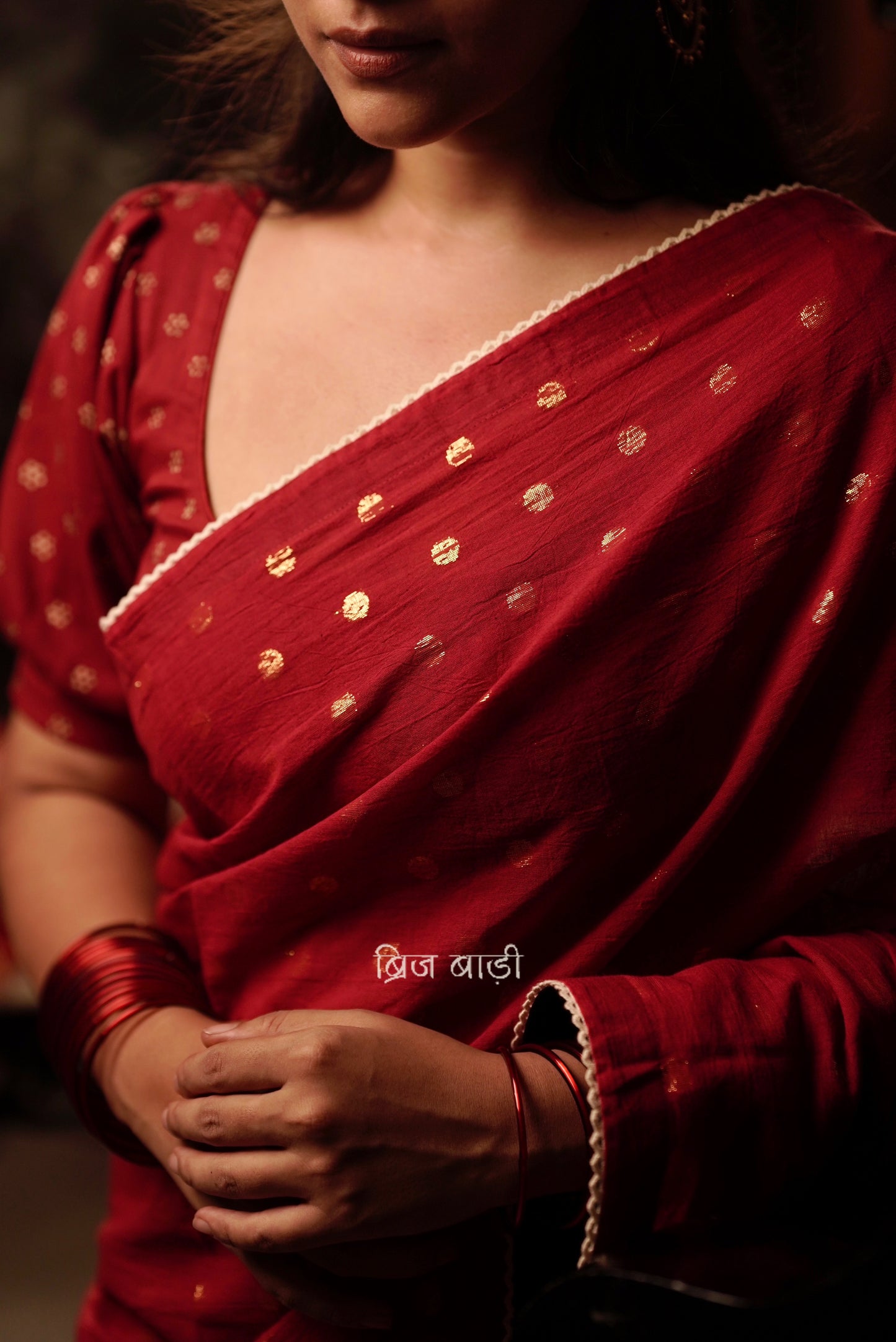 Brahmani deep red cotton saree with gold polka and crochet lace detailing and handmade thread tassel with ghungroo on palla