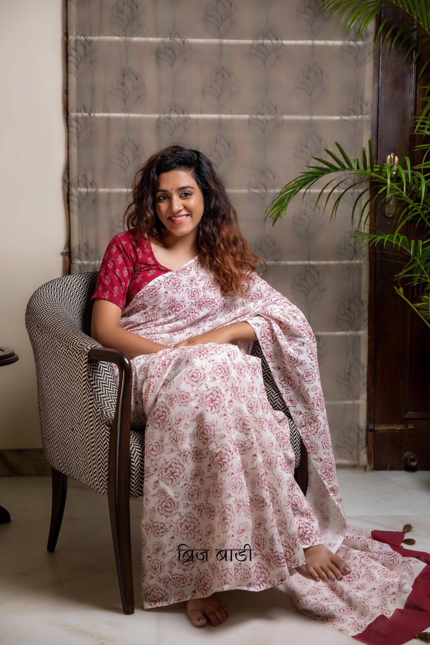 Off-white soft and light-weight cotton saree by Brij Bari, hand block printed with a delicate rose pattern for an elegant, understated everyday look. Crafted from breathable cotton, this saree ensures comfort and ease of wear, ideal for workdays, casual gatherings or daily summer dressing. The pallu is finished with bright olive green handmade thread tassels adding a traditional handcrafted detail to the look. Comes with a free hand block printed blouse piece designed to perfectly compliment the saree.