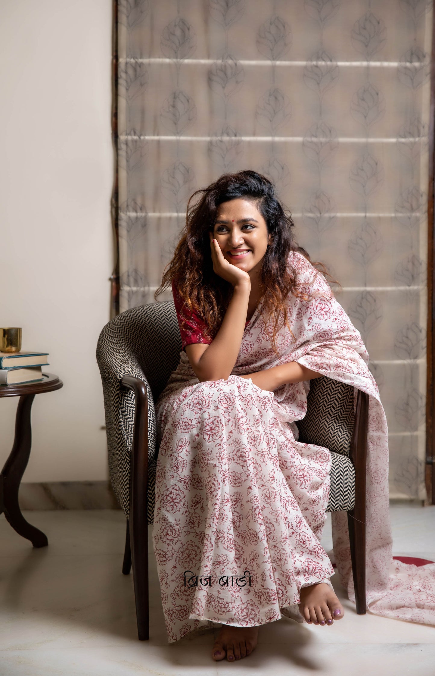 Off-white soft and light-weight cotton saree by Brij Bari, hand block printed with a delicate rose pattern for an elegant, understated everyday look. Crafted from breathable cotton, this saree ensures comfort and ease of wear, ideal for workdays, casual gatherings or daily summer dressing. The pallu is finished with bright olive green handmade thread tassels adding a traditional handcrafted detail to the look. Comes with a free hand block printed blouse piece designed to perfectly compliment the saree.