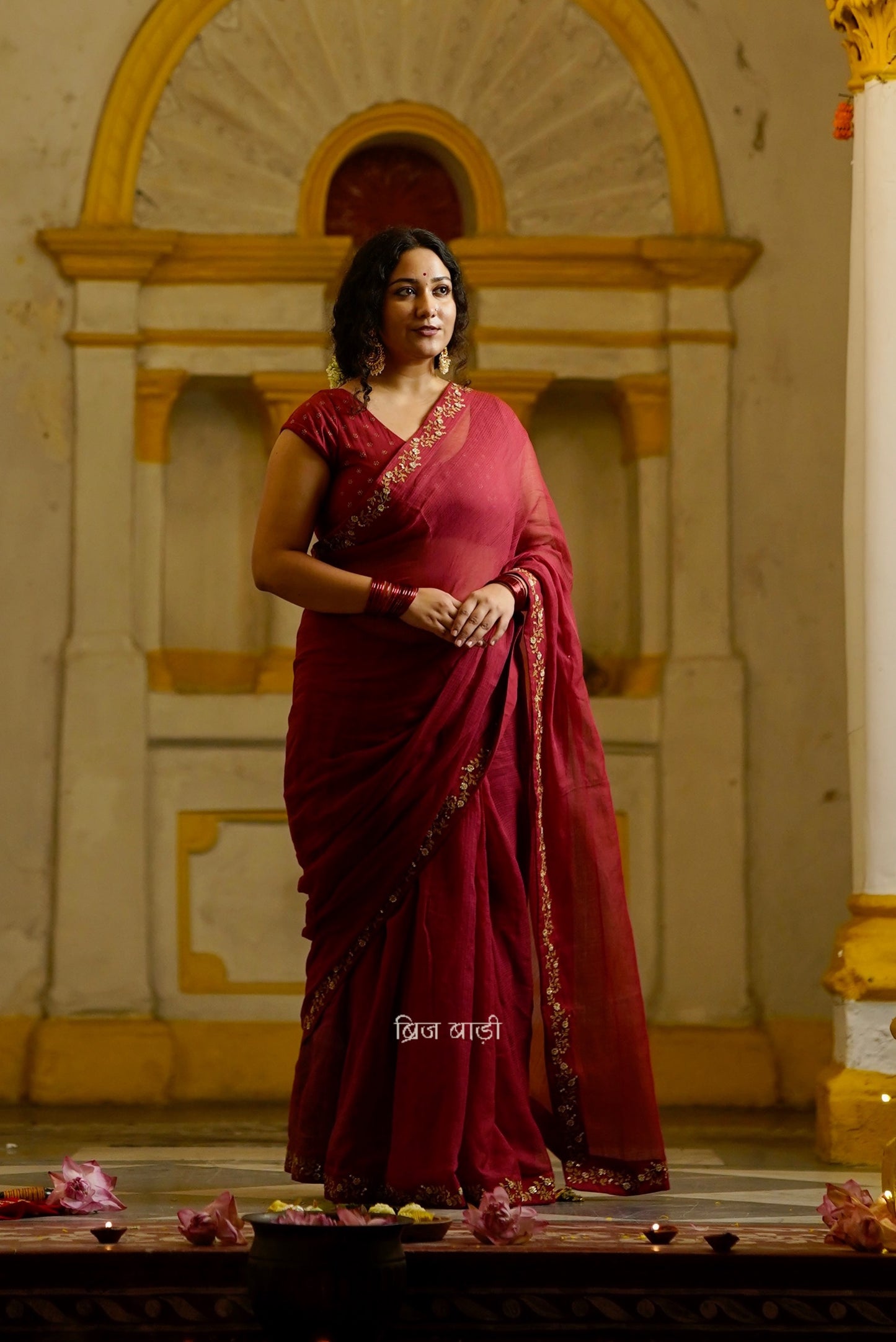 Jamuna handwoven deep-red colour Kota Doria saree with embroidered border and handmade thread tassel with ghungroo detailing on palla