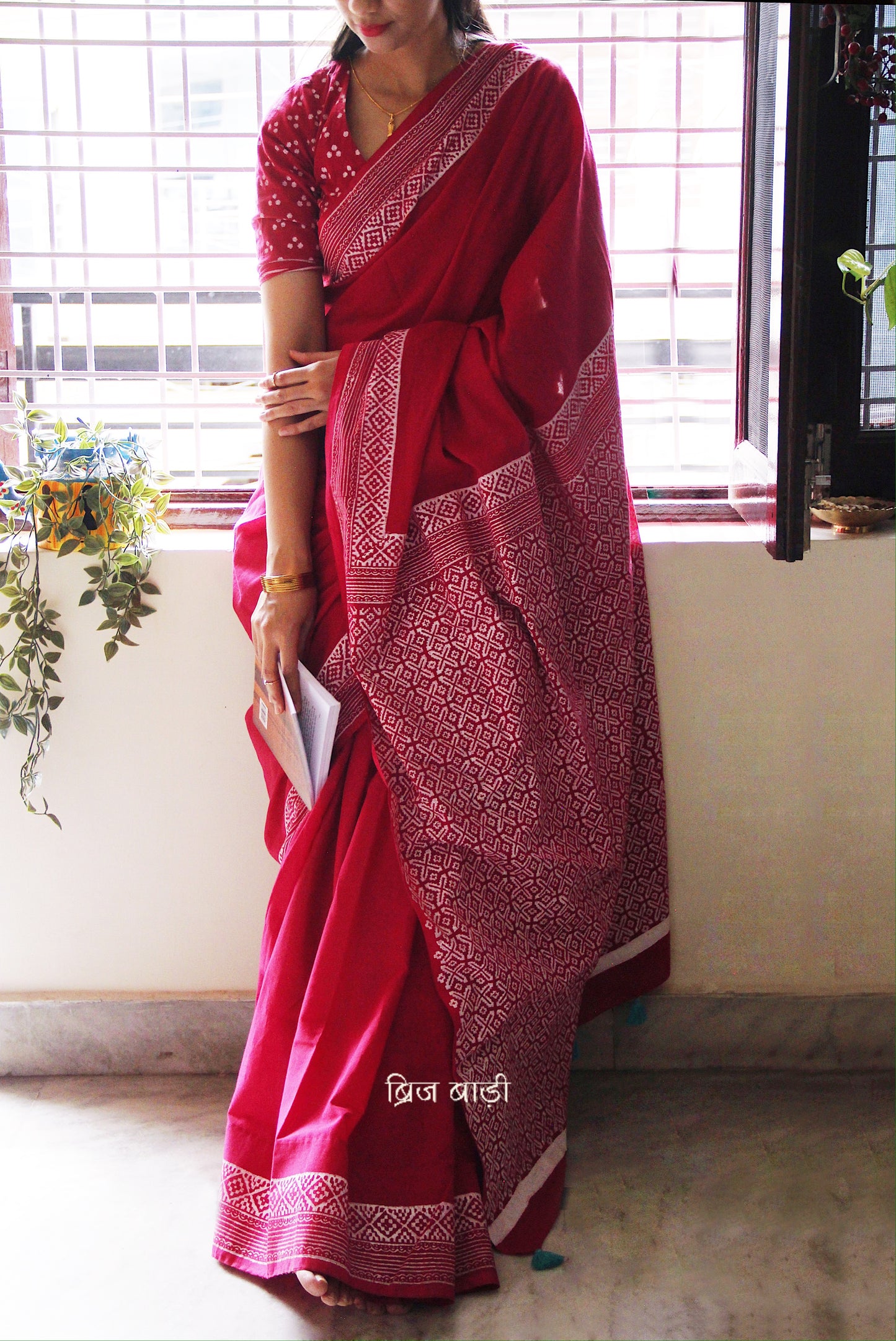 Soft and light-weight pink cotton saree by Brij Bari with intricate hand block printed detailing on the border and pallu for a refined, everyday aesthetic. Designed for effortless draping and breathable comfort this versatile saree is perfect for workdays, casual outings or understated occasions. Finished with delicate light blue handmade thread tassels on the pallu and paired with a free hand block printed blouse piece. A beautifully handcrafted daily wear staple from Brij Bari with free shipping pan India