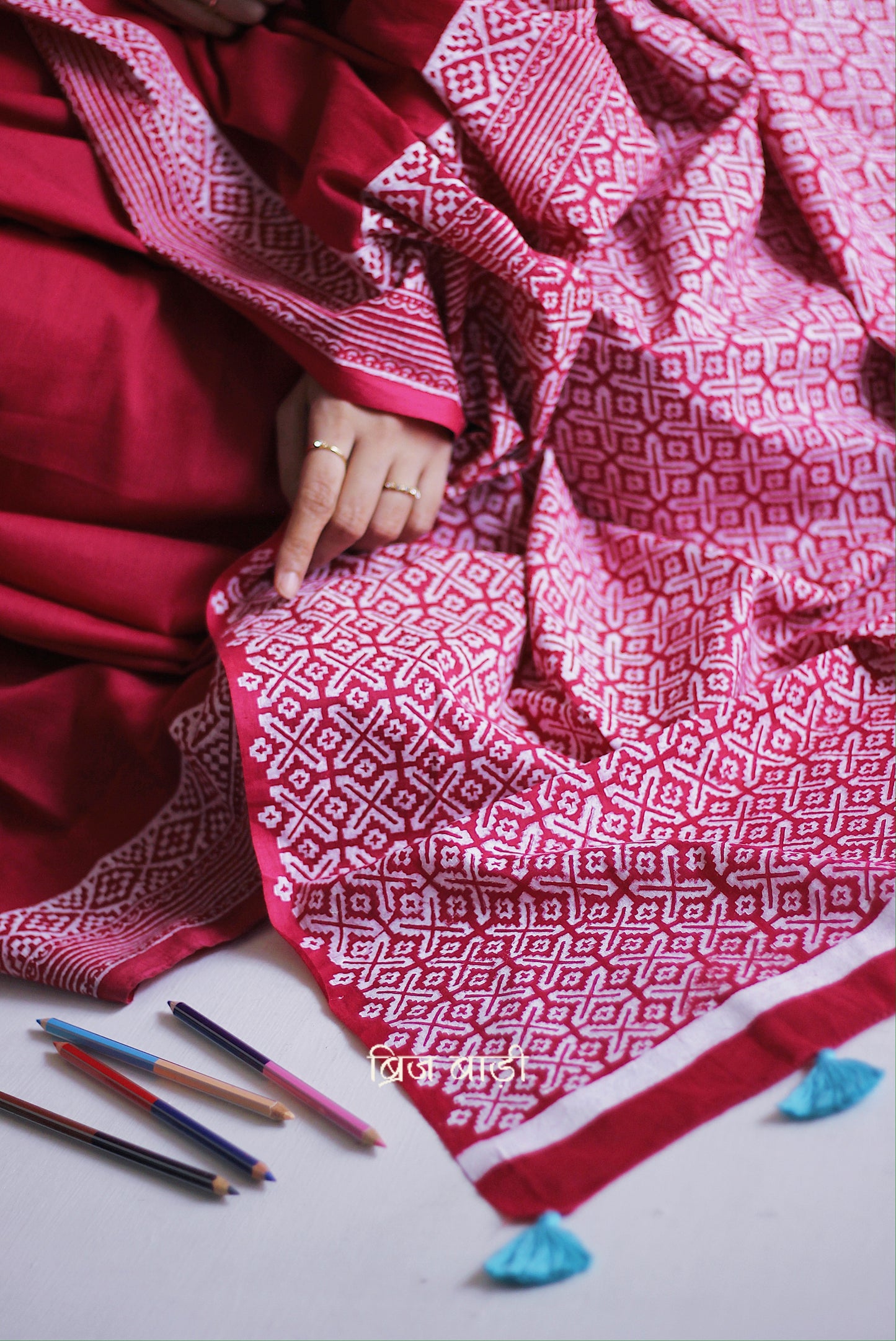 Soft and light-weight pink cotton saree by Brij Bari with intricate hand block printed detailing on the border and pallu for a refined, everyday aesthetic. Designed for effortless draping and breathable comfort this versatile saree is perfect for workdays, casual outings or understated occasions. Finished with delicate light blue handmade thread tassels on the pallu and paired with a free hand block printed blouse piece. A beautifully handcrafted daily wear staple from Brij Bari with free shipping pan India