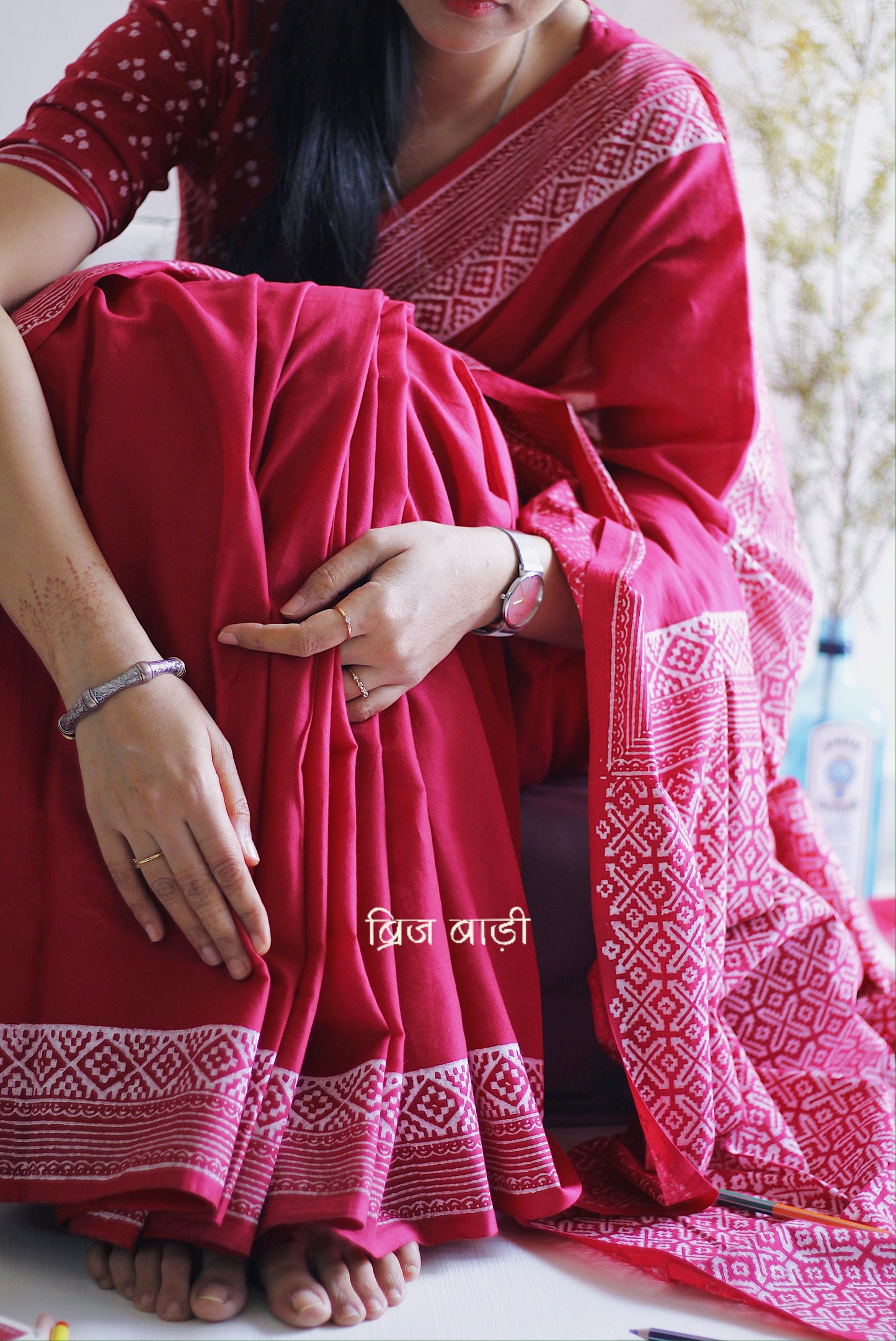 Soft and light-weight pink cotton saree by Brij Bari with intricate hand block printed detailing on the border and pallu for a refined, everyday aesthetic. Designed for effortless draping and breathable comfort this versatile saree is perfect for workdays, casual outings or understated occasions. Finished with delicate light blue handmade thread tassels on the pallu and paired with a free hand block printed blouse piece. A beautifully handcrafted daily wear staple from Brij Bari with free shipping pan India