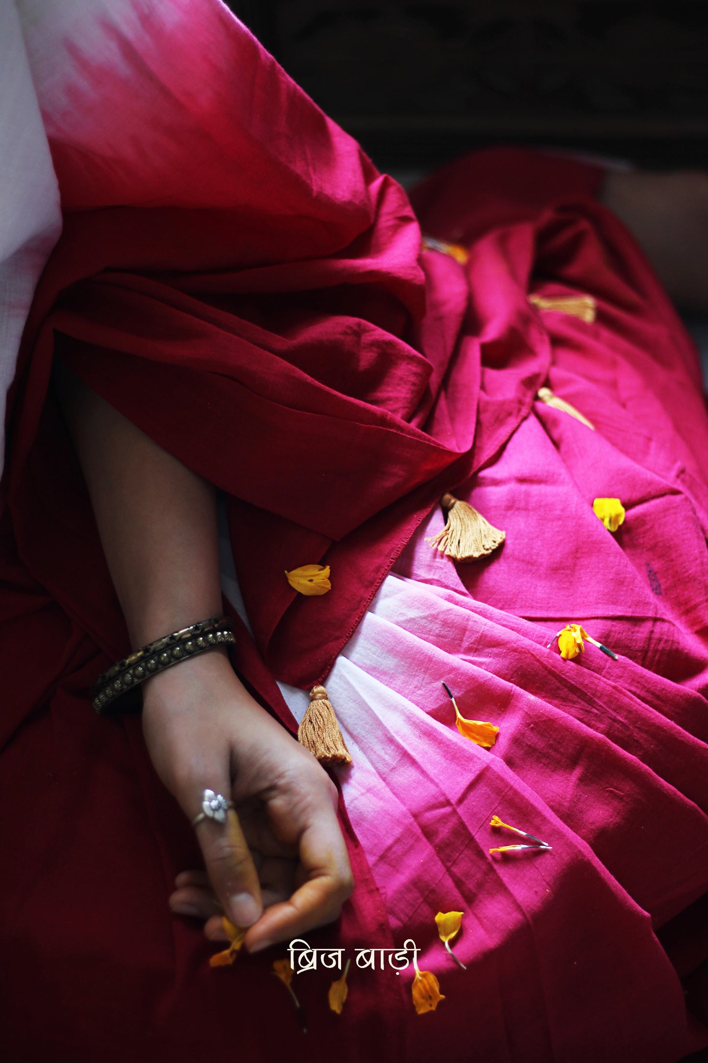 Red and off-white ombré soft cotton saree by Brij Bari, crafted for effortless elegance and all-day comfort. The subtle blend of tones adds fluidity and grace to the drape, making it perfect for both everyday wear and special occasions. The pallu is adorned with handcrafted mustard thread tassels, lending a warm, artisanal touch. It comes with a free hand block printed blouse piece that complements the saree’s minimal yet striking aesthetic. Available in 8 beautiful colour options