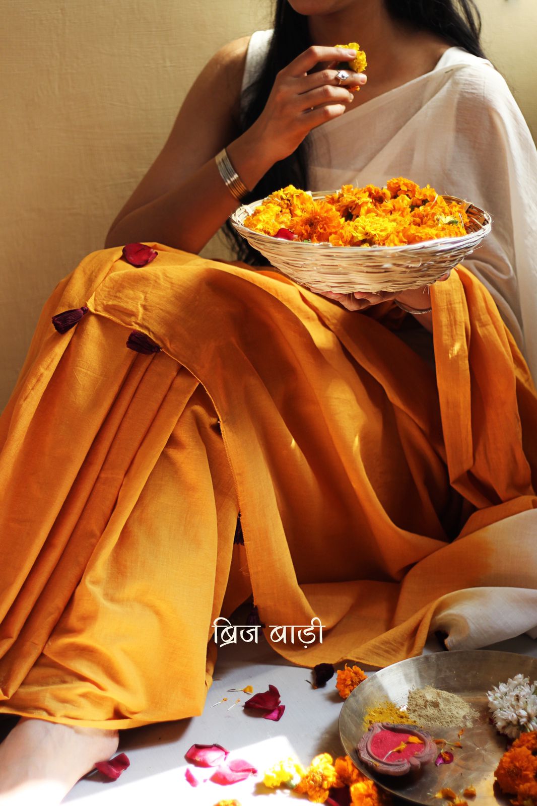 Yellow and off-white ombré soft cotton saree by Brij Bari, crafted for effortless elegance and all-day comfort. The subtle blend of tones adds fluidity and grace to the drape, making it perfect for both everyday wear and special occasions. The pallu is adorned with handcrafted purple thread tassels, lending a warm, artisanal touch. It comes with a free hand block printed blouse piece that complements the saree’s minimal yet striking aesthetic. Available in 8 beautiful colour options