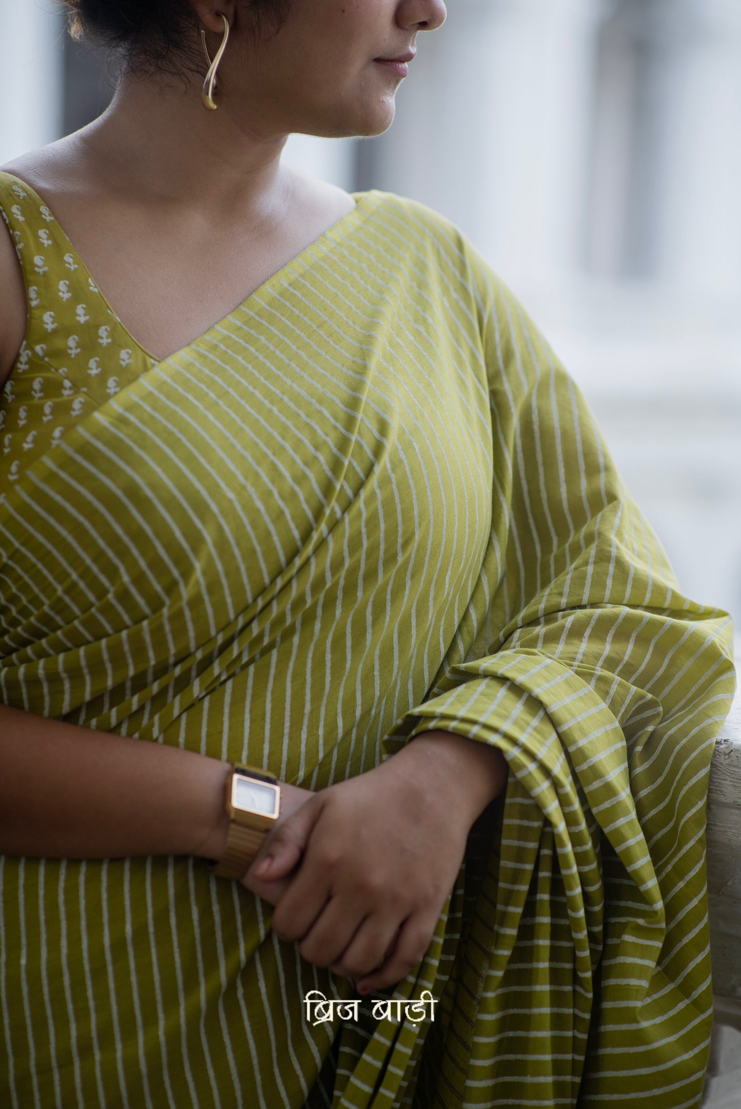 Light green soft and lightweight cotton saree by Brij Bari, hand block printed with pink and white stripe pattern. Finished with handmade yellow thread tassels on the pallu. Includes a free block printed cotton blouse piece. A versatile saree designed to add a vibrant pop of colour to your everyday wardrobe while ensuring breathable comfort and effortless style. Free shipping pan India.