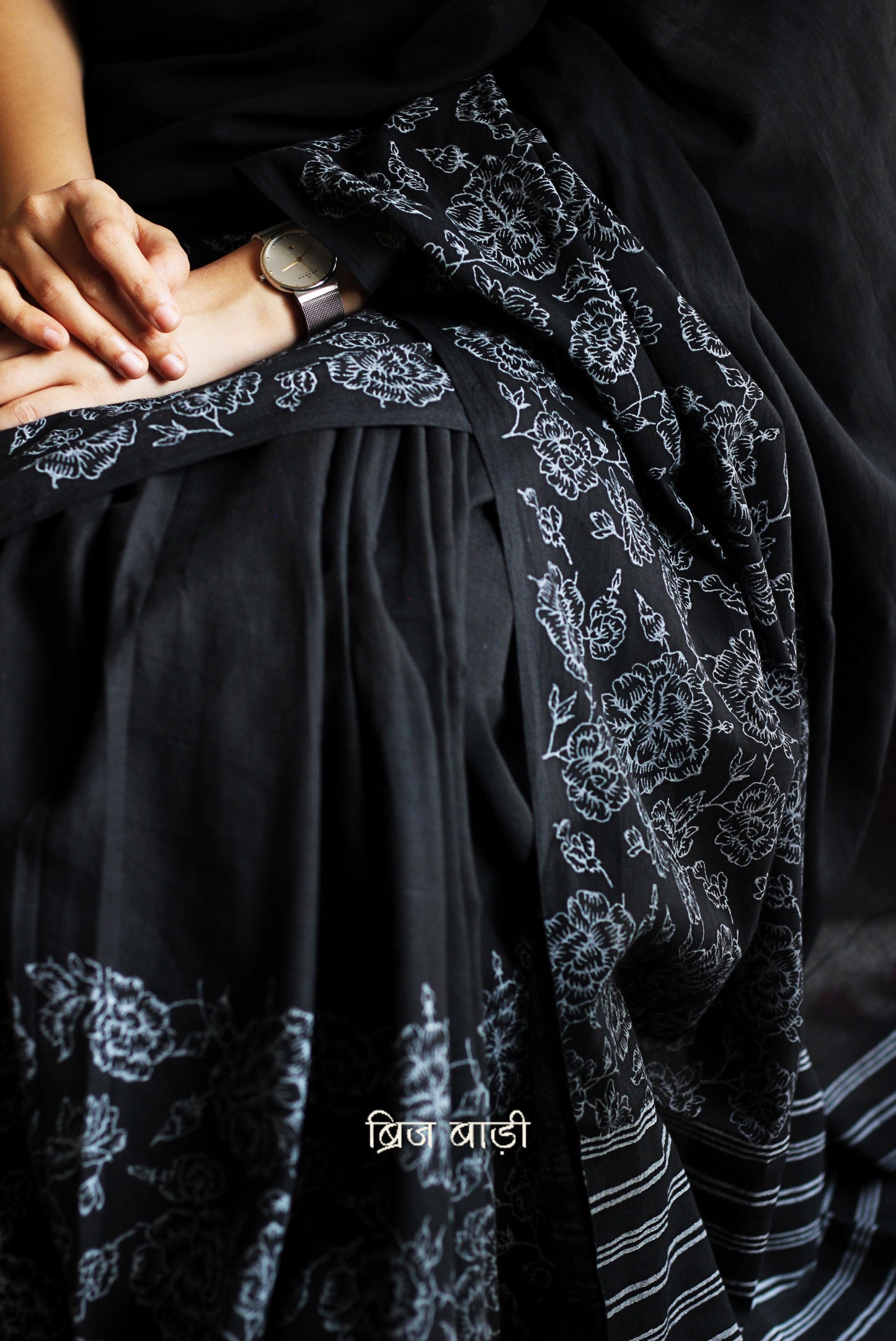 Black soft and light-weight cotton saree by Brij Bari, hand block printed with a graceful rose pattern on the skirt and contrasting bold stripes on the pallu. This versatile, breathable saree is designed for everyday ease — lightweight, elegant, and comfortable, perfect for casual outings & office wear. Finished with charming pink handmade thread tassels on the pallu. Comes with a free hand block printed blouse piece designed to compliment the sare’s floral and striped patterns. Free shipping pan India.