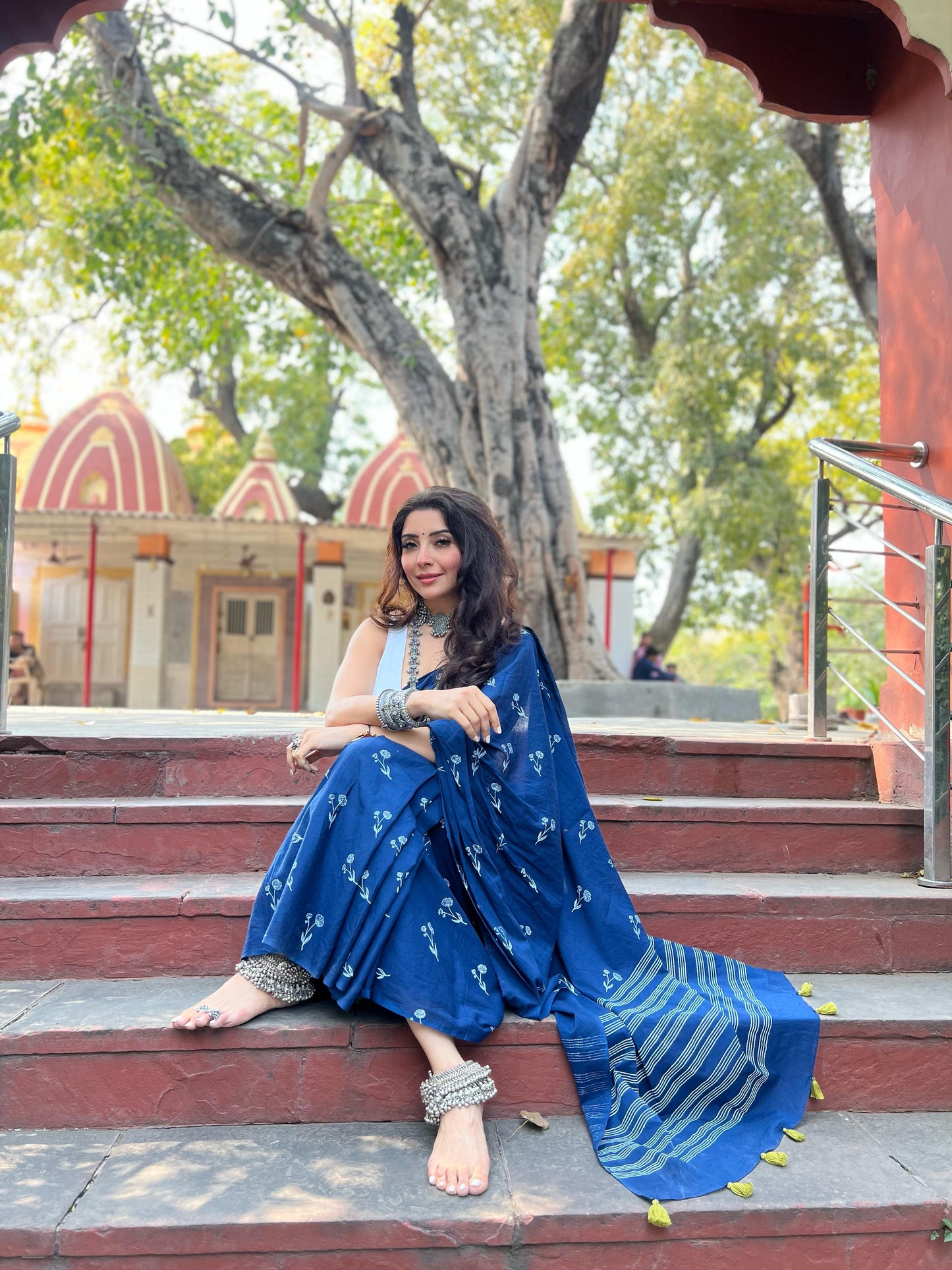 Renowned astrologisy Jai Madaan in our Aparajita blue hand block printed cotton saree with intricate floral motifs, lightweight and breathable fabric, includes a free matching blouse piece – perfect for everyday and festive wear.