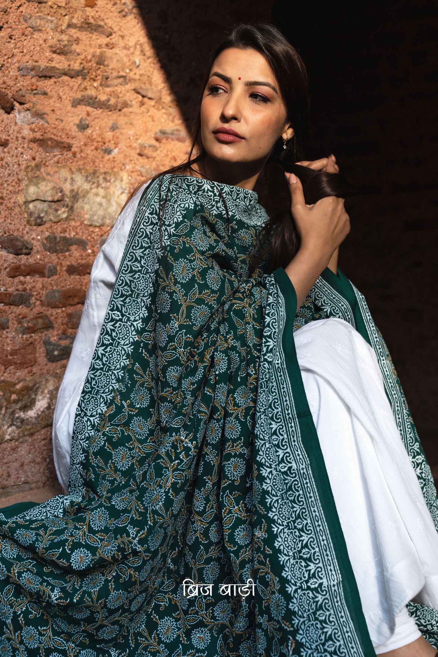 Dark green soft and lightweight cotton dupatta by Brij Bari, hand block printed with a beautiful floral pattern that brings out its artisanal charm. Finished with handcrafted mustard thread tassels on both ends of the pallu, this dupatta offers breathable comfort and a versatile look that pairs beautifully with everyday suits. Free shipping pan India.