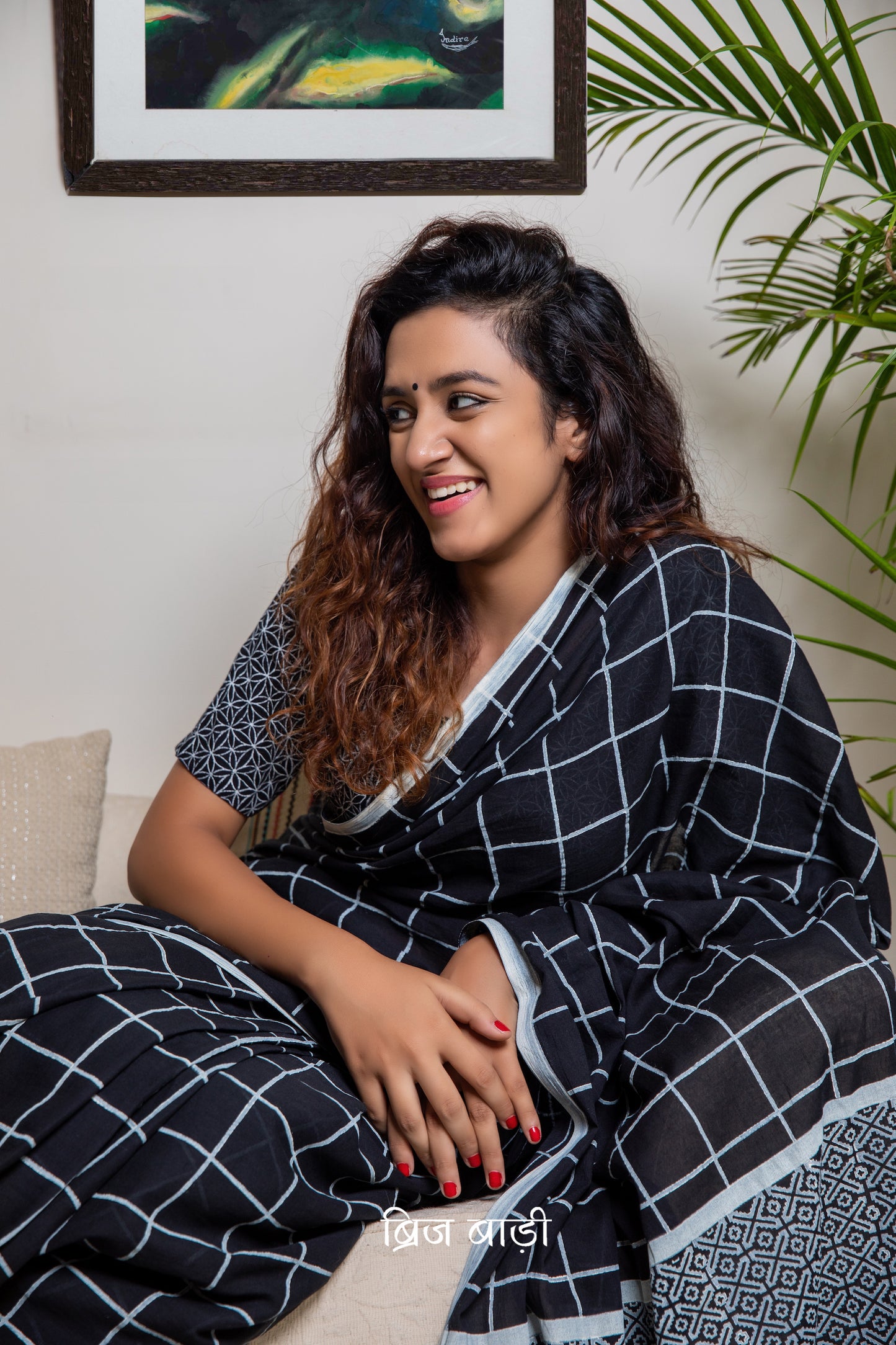 Stay cool and elegant in this black cotton saree with hand block checks, handmade tassels on the pallu, and a free blouse piece – perfect for all-day comfort.