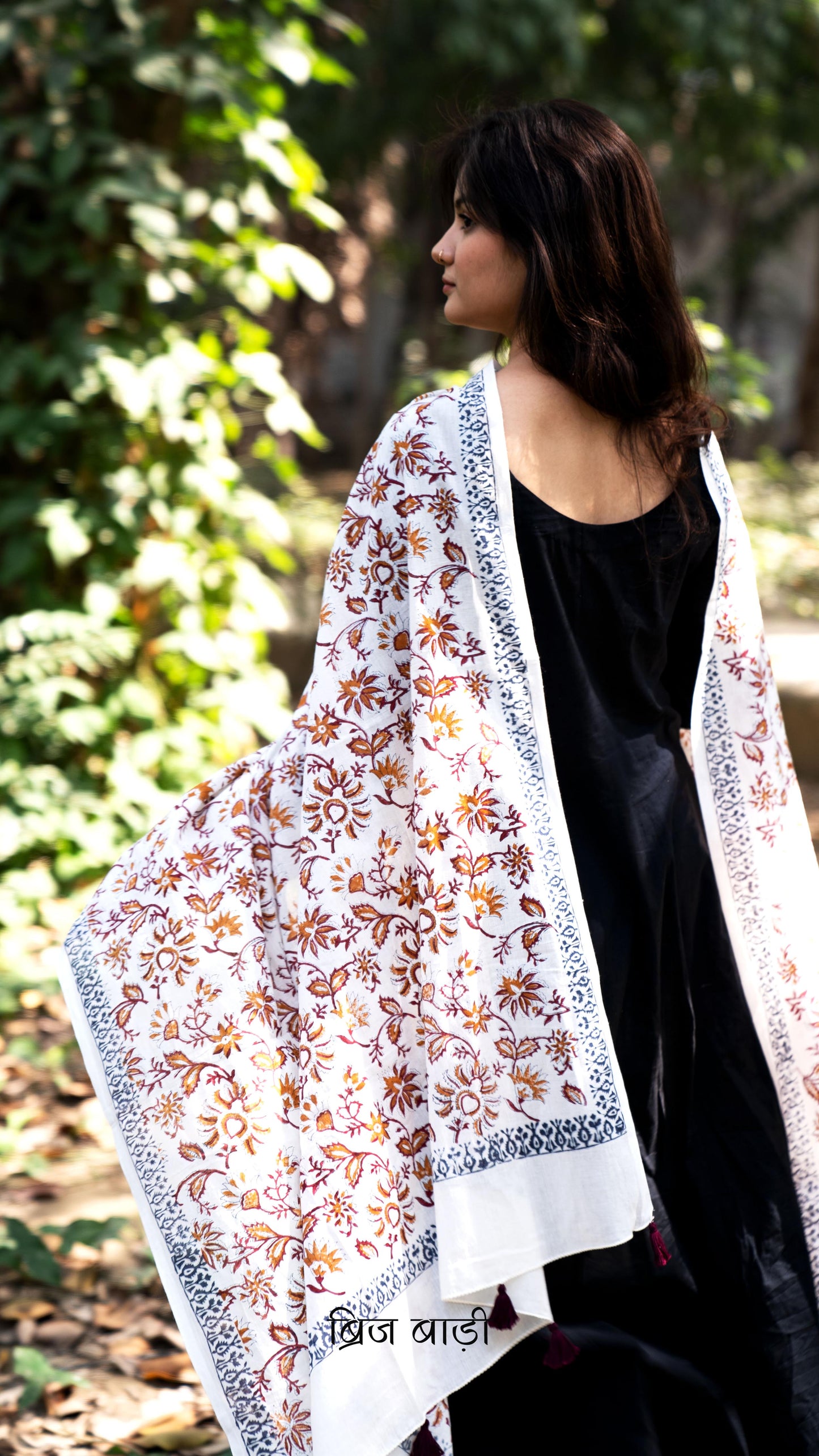 Off white soft and lightweight cotton dupatta by Brij Bari, hand block printed with a vibrant multicolour floral pattern. Finished with handmade purple thread tassels on both ends of the pallu, this artisanal dupatta adds a lively pop of colour to your daily suits while offering all-day breathable comfort. Ideal for versatile styling. Free shipping pan India.