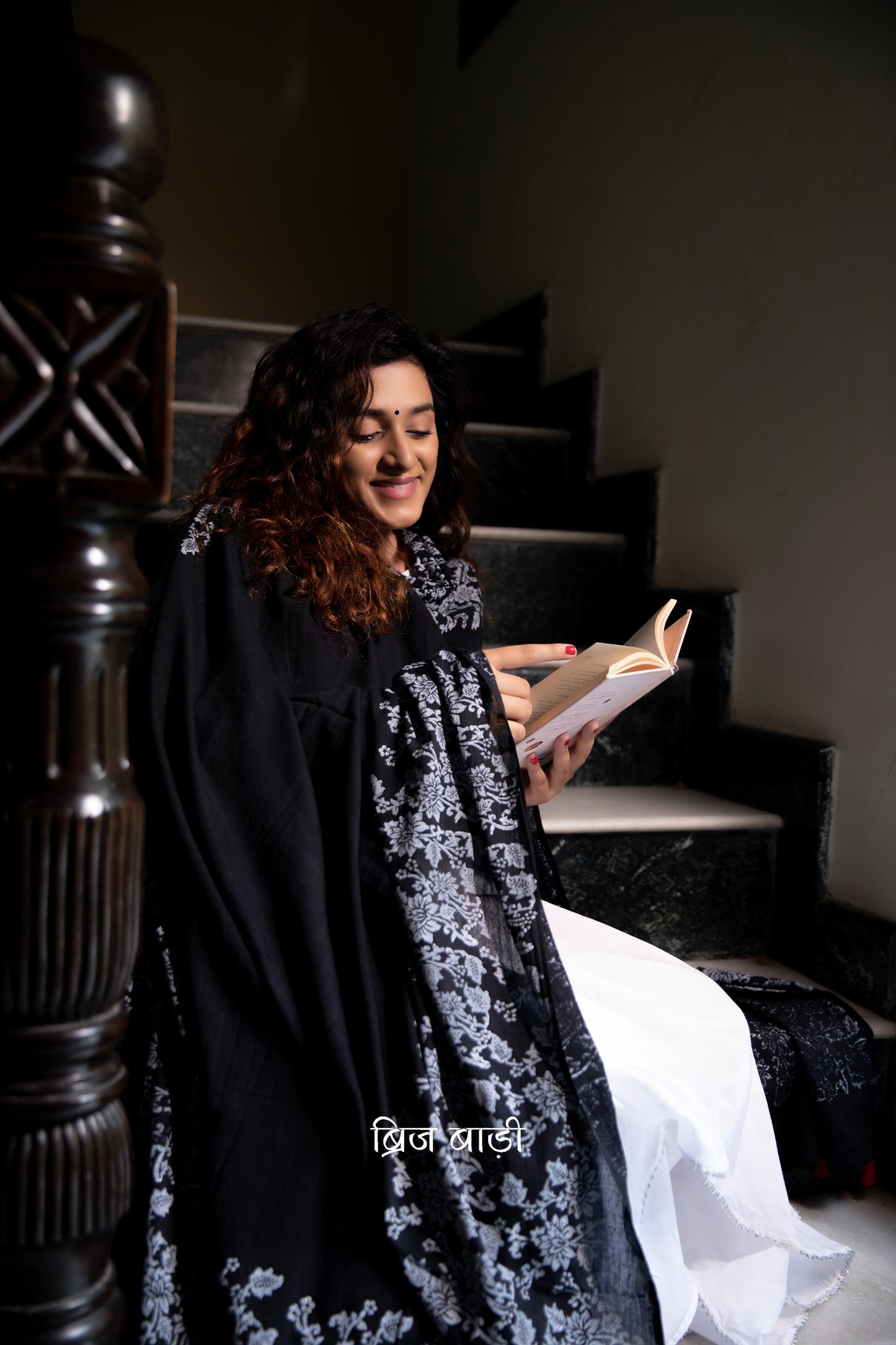 Black soft and light-weight cotton dupatta by Brij Bari, adorned with an elegant floral border hand block printed in crisp white, creating a striking contrast against the deep black base. Crafted from breathable, airy cotton fabric, this dupatta is ideal to pair with suits, kurtas, or ethnic sets, adding a refined handcrafted touch to both everyday and occasion wear. The pallu is finished with vibrant red handmade thread tassels, offering a playful, artisanal accent to the look.