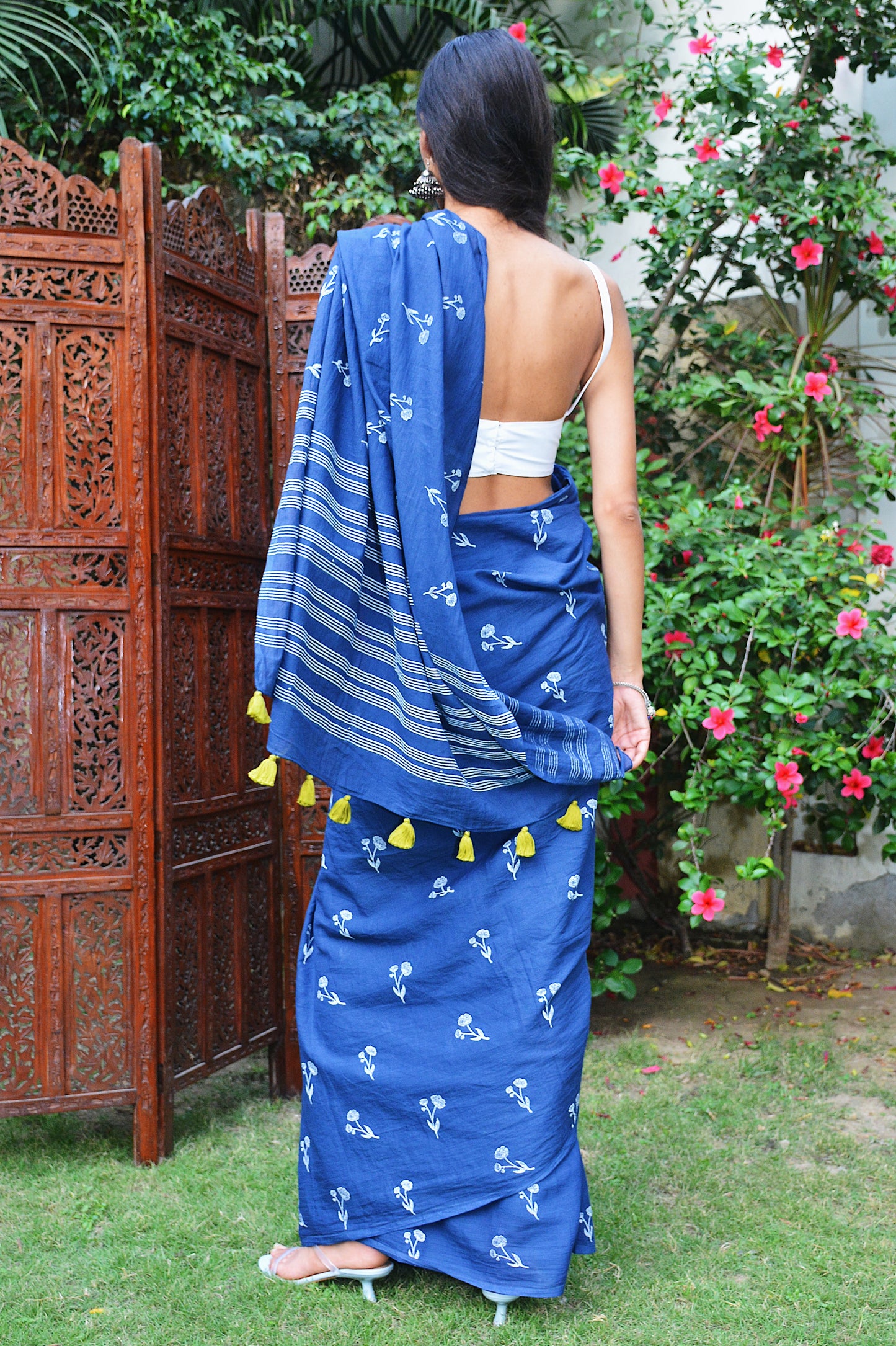 Blue hand block printed cotton saree with intricate floral motifs, lightweight and breathable fabric, includes a free matching blouse piece – perfect for everyday and festive wear.