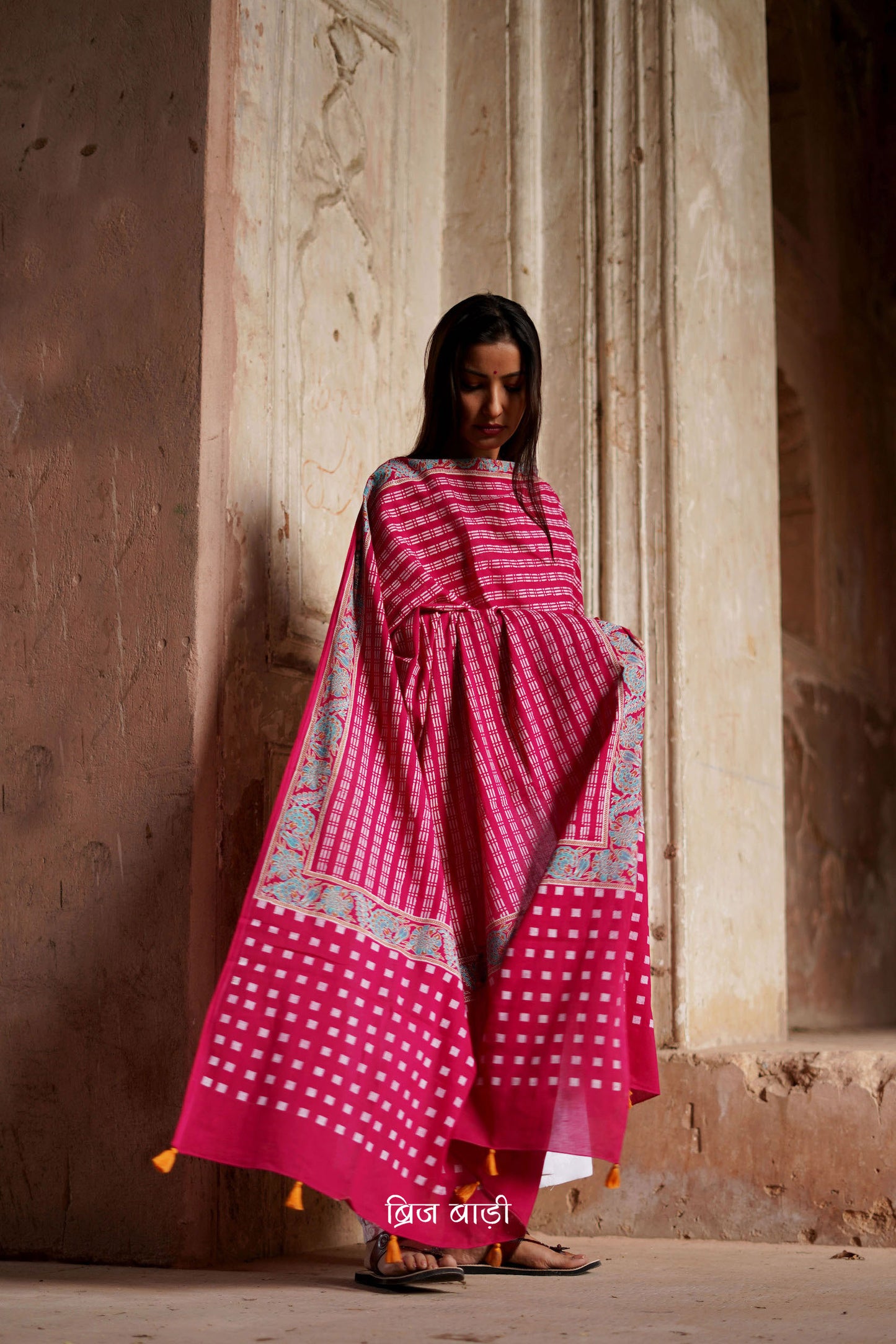 Pink soft and lightweight cotton dupatta by Brij Bari, hand block printed with a striking geometric pattern that adds a touch of artisanal detail. Finished with light blue handmade thread tassels on both ends of the pallu, this dupatta is a vibrant addition to your daily wear—offering a pop of colour, breathable comfort, and effortless style. Free shipping pan India.