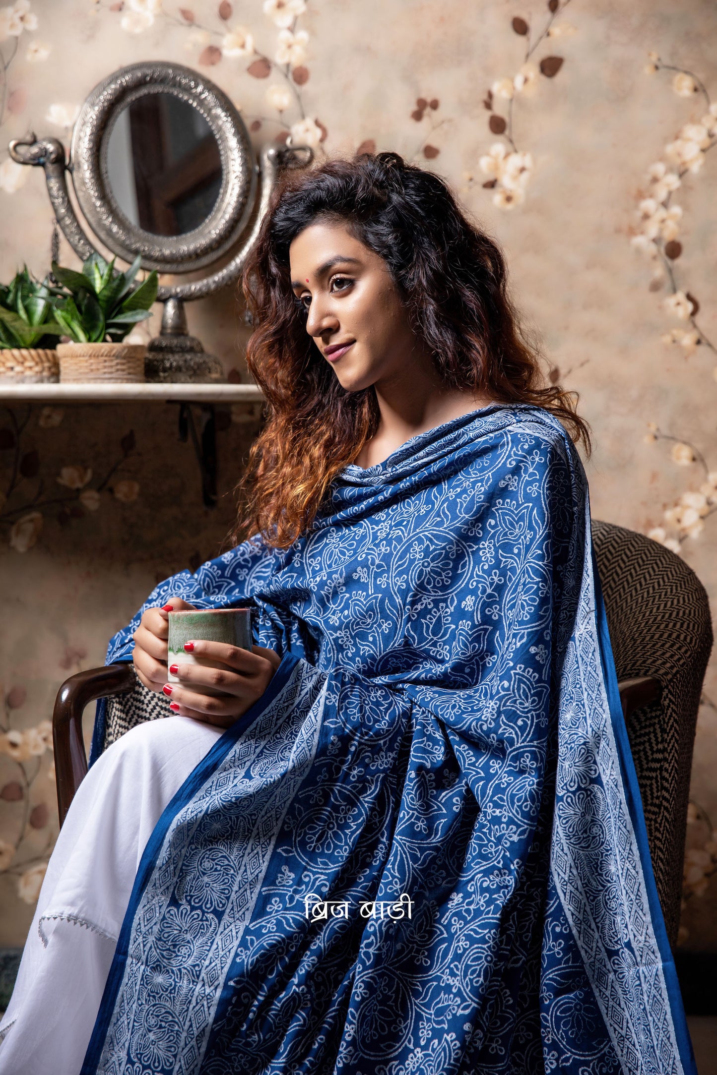 Blue soft and light-weight cotton dupatta by Brij Bari hand block printed with a delicate floral pattern in classic white, offering a timeless, elegant look. Crafted in breathable cotton, this dupatta is perfect to pair with suits, kurtas, or casual ethnic wear adding a fresh, handcrafted charm to everyday and festive outfits. The pallu is adorned with vibrant red handmade thread tassels, lending a playful, artisanal touch. Its versatile design makes it suitable for both everyday wear and special occasion.