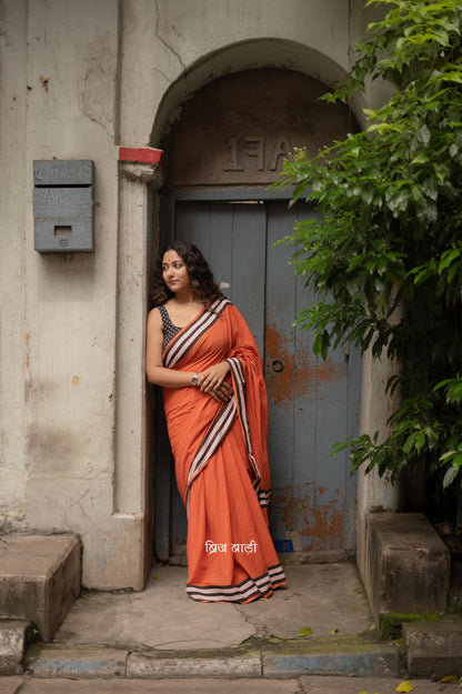 Rust soft cotton hand block printed saree with intricate design and contrast thread tassels, perfect for elegant and comfortable wear on any occasion.