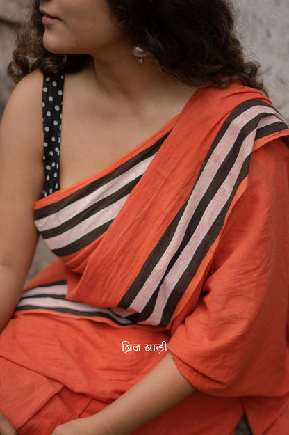 Anindita Rust Orange cotton saree with black and white stripe hand block printed border