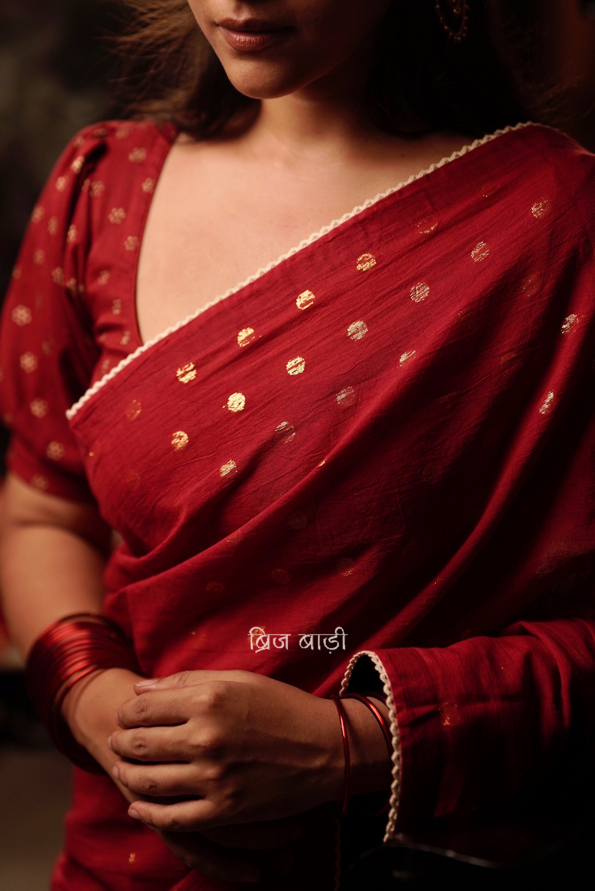 Brahmani deep red cotton saree with gold polka and crochet lace detailing and handmade thread tassel with ghungroo on palla