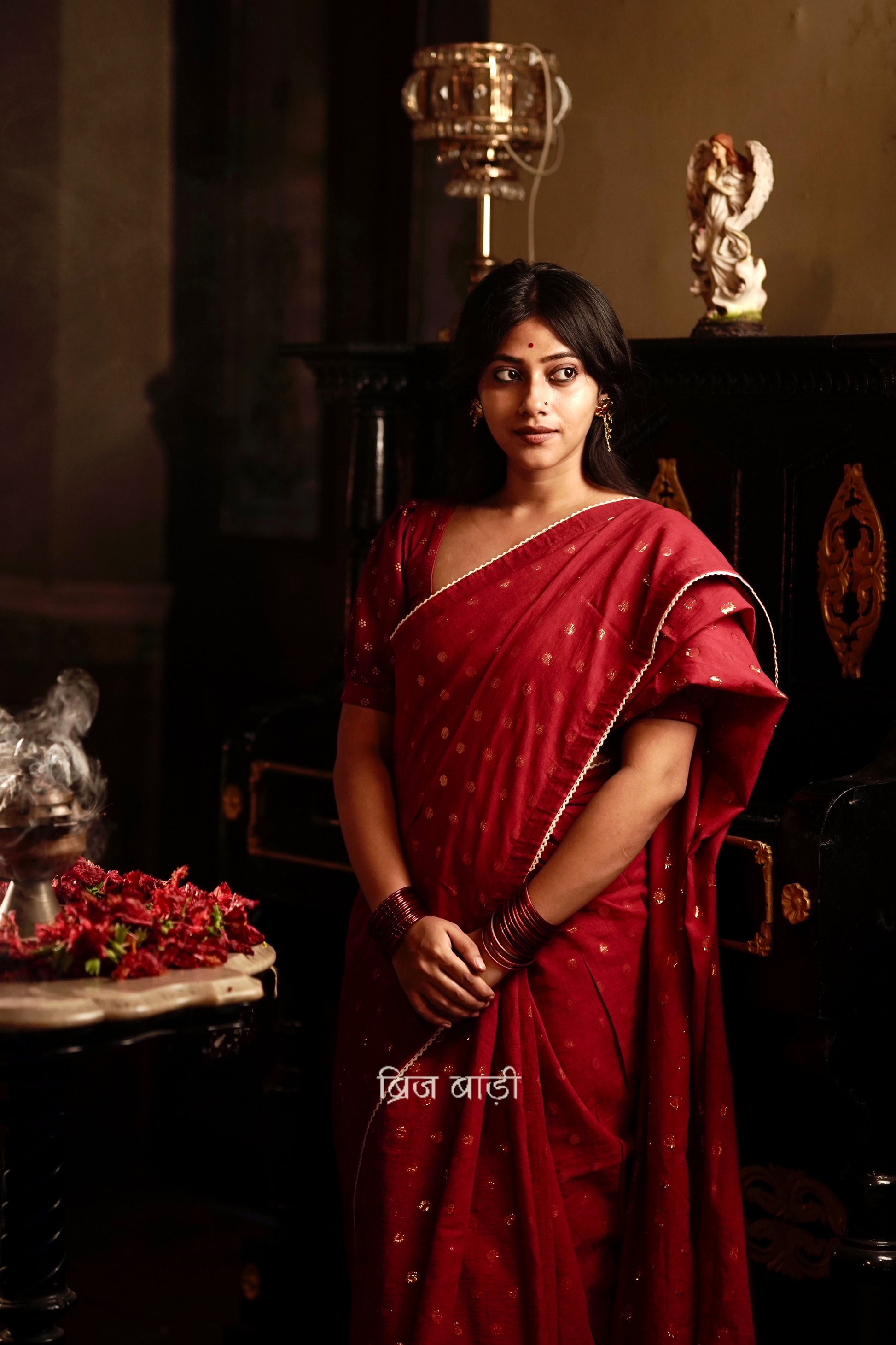 Brahmani deep red cotton saree with gold polka and crochet lace detailing and handmade thread tassel with ghungroo on palla