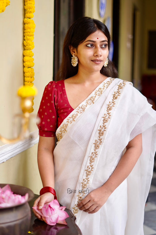Ganga handwoven off-white Kota Doria saree with hand-embroidered border and thread tassel with ghungroo detailing on palla