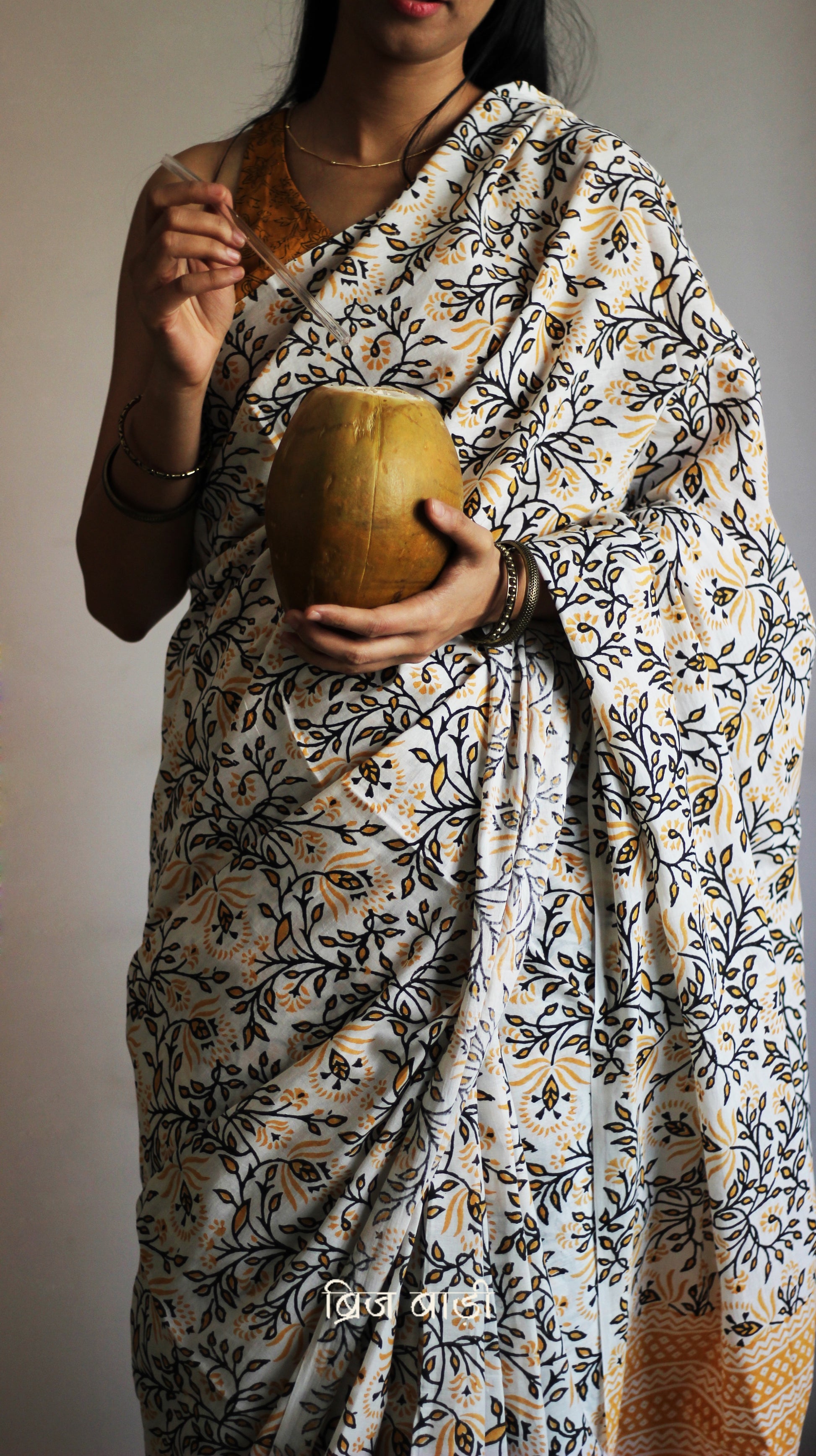 Yellow cotton saree with floral hand block prints, artisan- handcrafted with handmade thread tassels on pallu. Comes with a soft, breathable printed blouse piece.