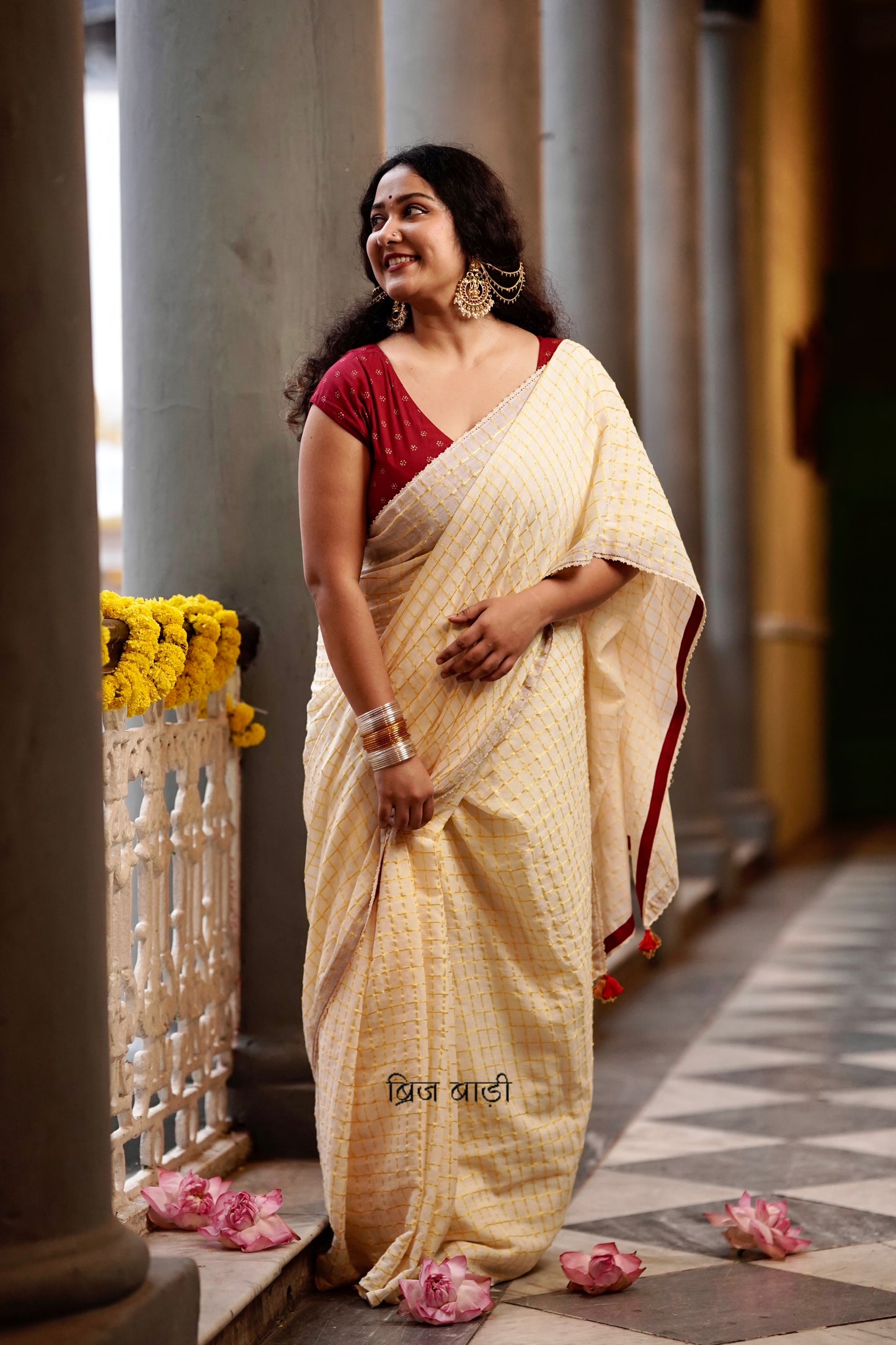 Gomti off-white cotton saree with gold checks and crochet lace detailing with handmade thread tassel & ghungroo detailing on the palla