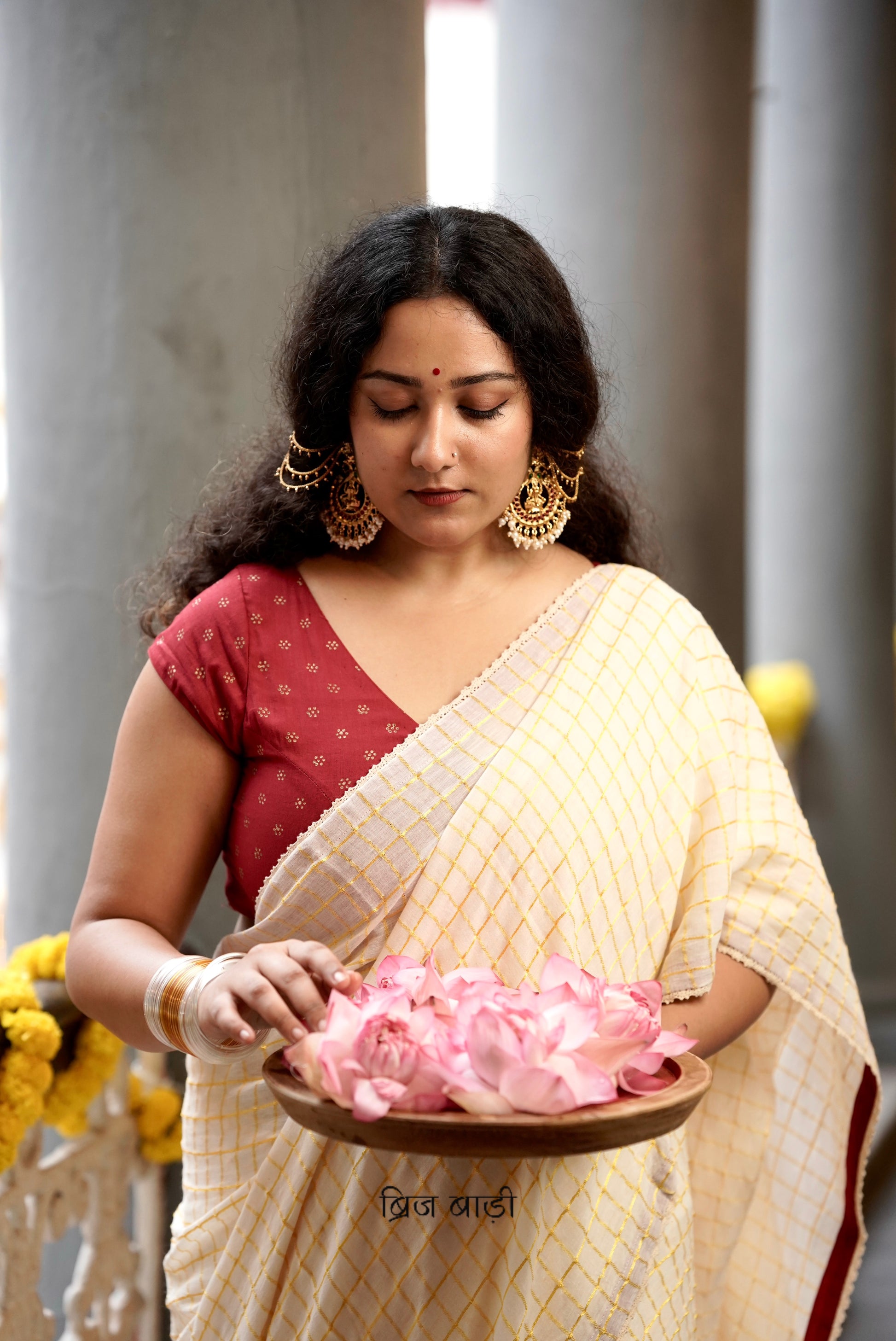 Gomti off-white cotton saree with gold checks and crochet lace detailing with handmade thread tassel & ghungroo detailing on the palla