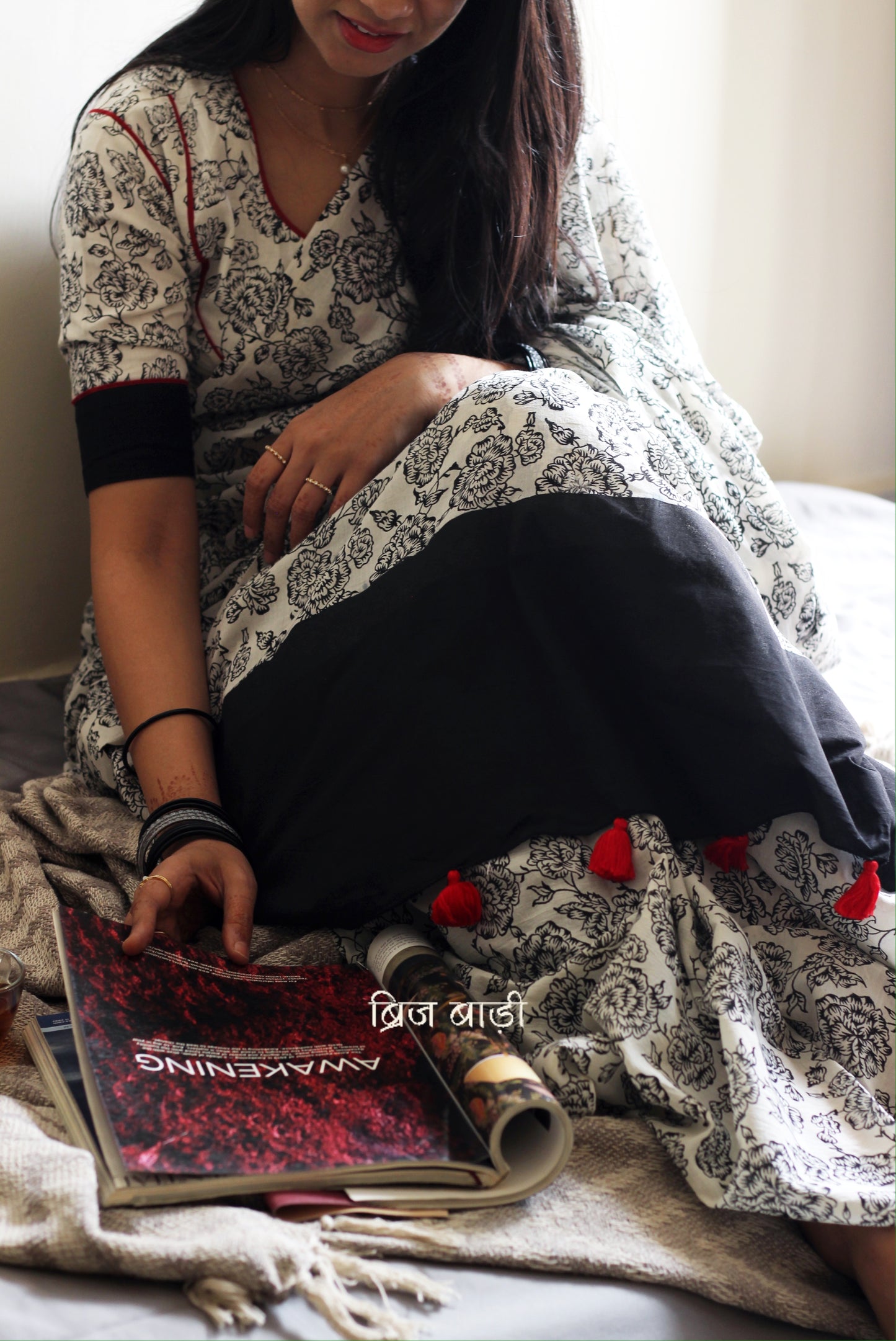 Off-white soft and light-weight cotton saree by Brij Bari, hand block printed with a delicate rose pattern for an elegant, understated everyday look. Crafted from breathable cotton, this saree ensures comfort and ease of wear, ideal for workdays, casual gatherings or daily summer dressing. The pallu is finished with red handmade thread tassels adding a traditional handcrafted detail to the look. Comes with a free hand block printed blouse piece designed to perfectly compliment the saree. 