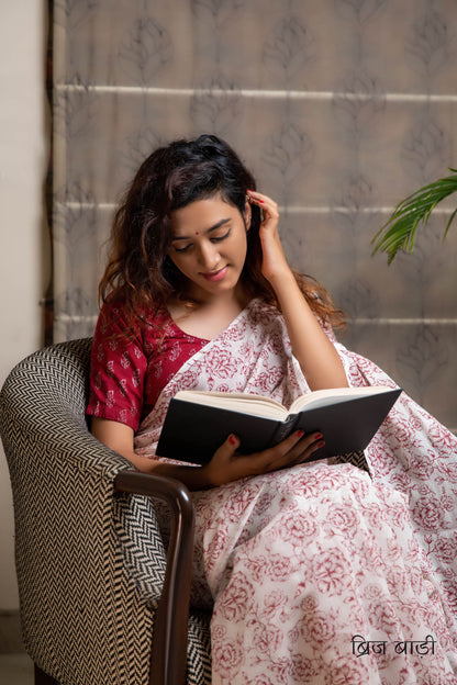 Off-white soft and light-weight cotton saree by Brij Bari, hand block printed with a delicate rose pattern for an elegant, understated everyday look. Crafted from breathable cotton, this saree ensures comfort and ease of wear, ideal for workdays, casual gatherings or daily summer dressing. The pallu is finished with bright olive green handmade thread tassels adding a traditional handcrafted detail to the look. Comes with a free hand block printed blouse piece designed to perfectly compliment the saree. 