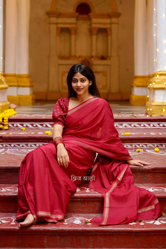 Iravati deep red cotton saree with hand block-printed gold border and handmade thread tassel on pallu