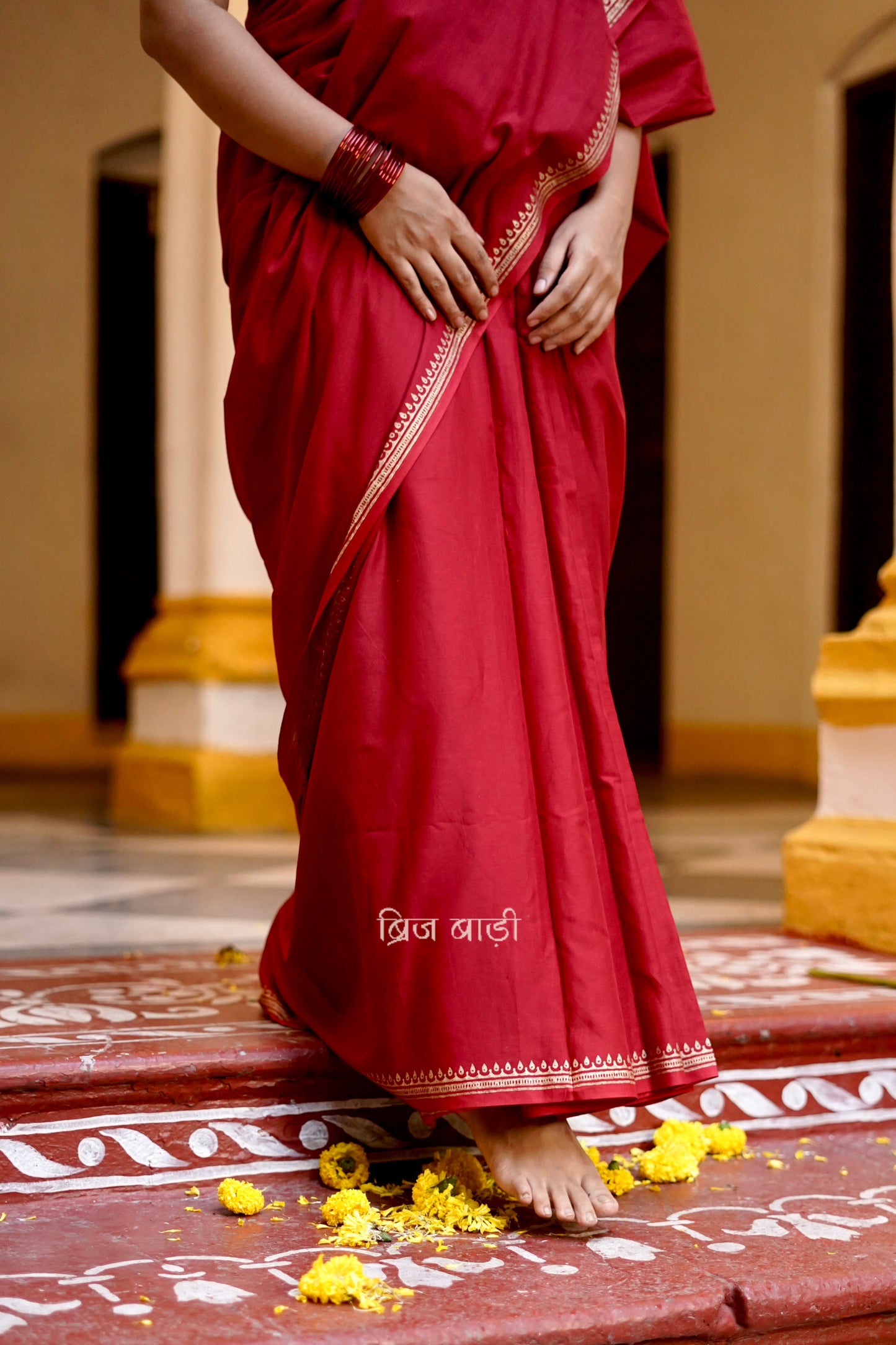 Iravati deep red cotton saree with hand block-printed gold border and handmade thread tassel on pallu
