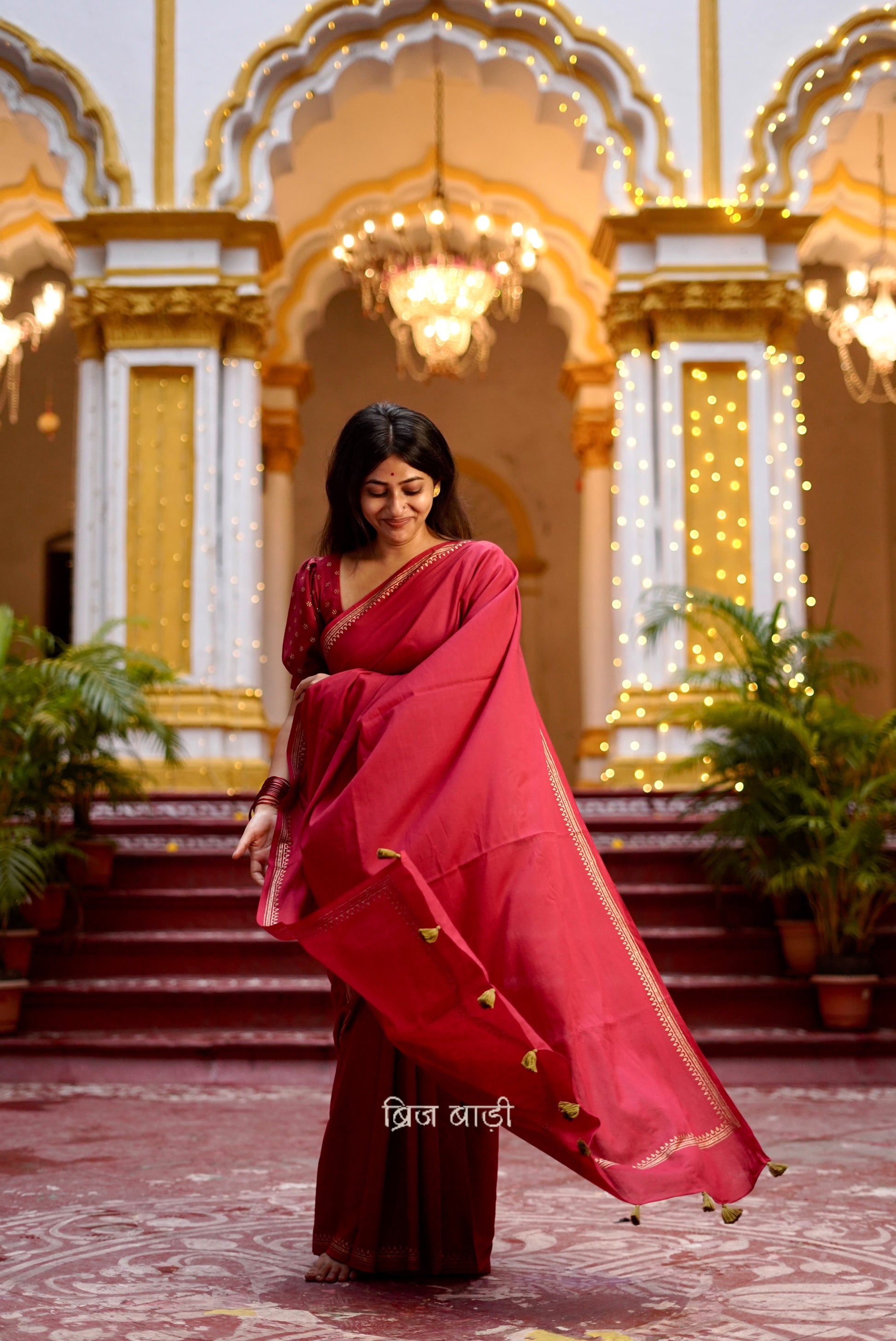 Iravati deep red cotton saree with hand block-printed gold border and handmade thread tassel on pallu