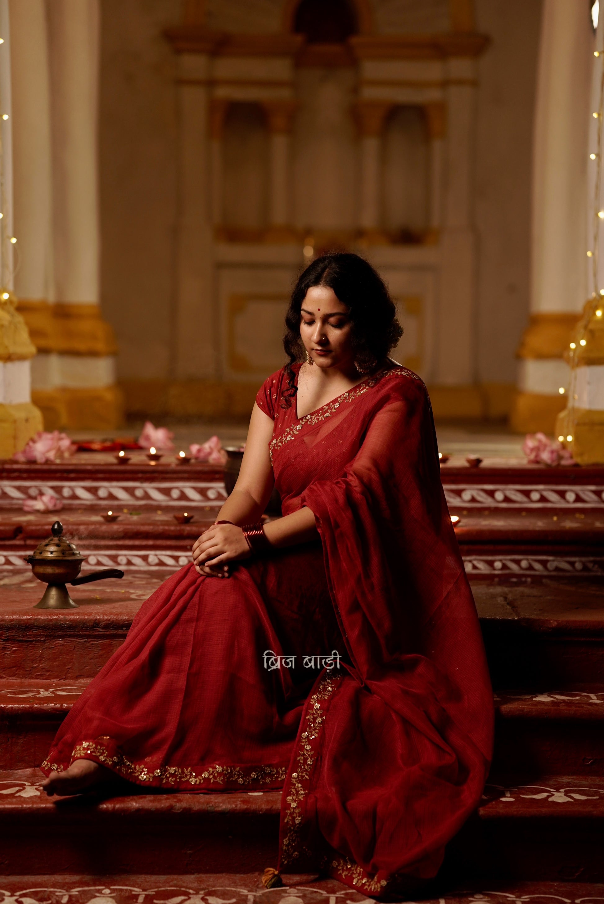 Jamuna handwoven deep-red colour Kota Doria saree with embroidered border and handmade thread tassel with ghungroo detailing on palla