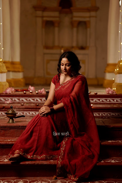 Jamuna handwoven deep-red colour Kota Doria saree with embroidered border and handmade thread tassel with ghungroo detailing on palla