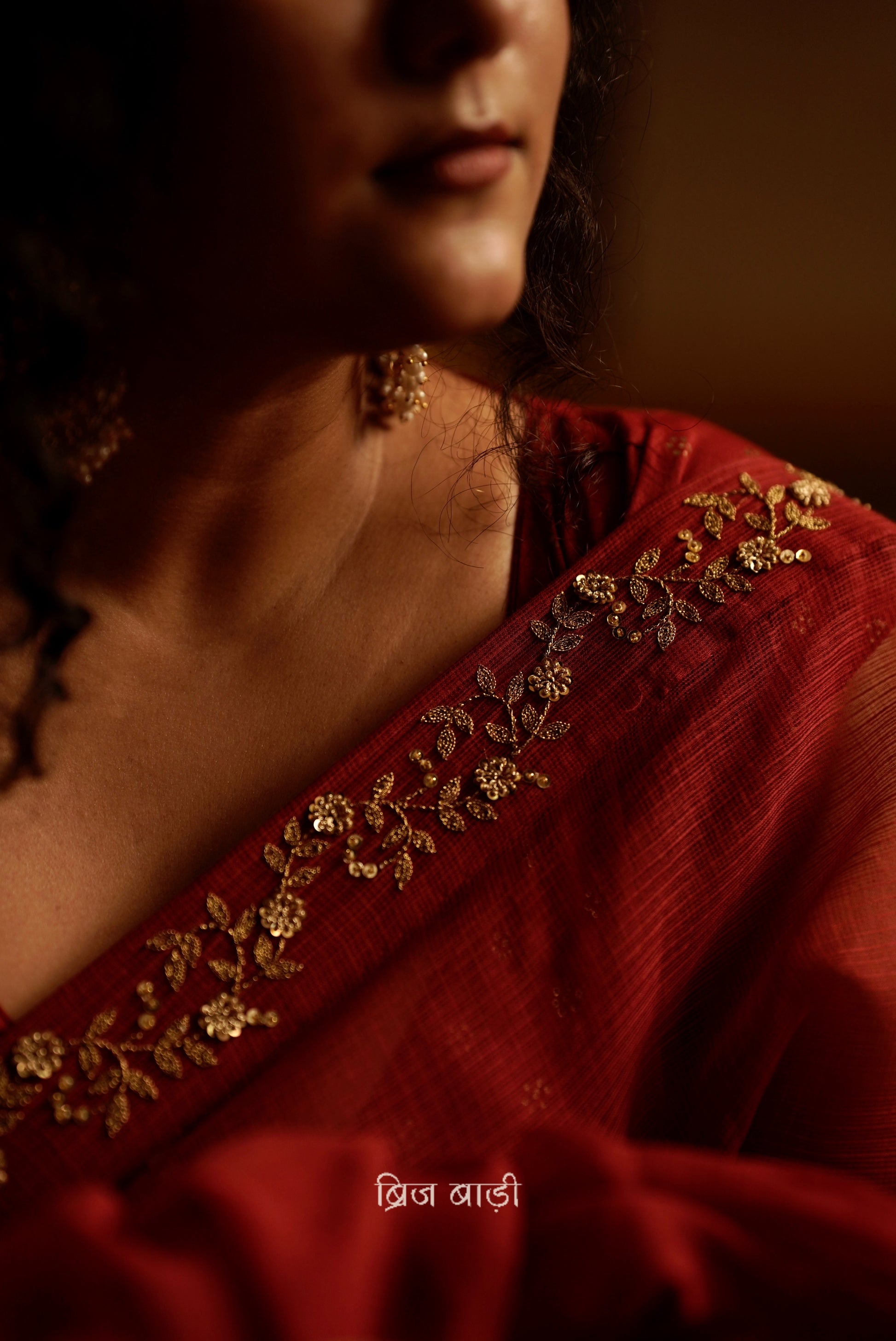 Jamuna handwoven deep-red colour Kota Doria saree with embroidered border and handmade thread tassel with ghungroo detailing on palla