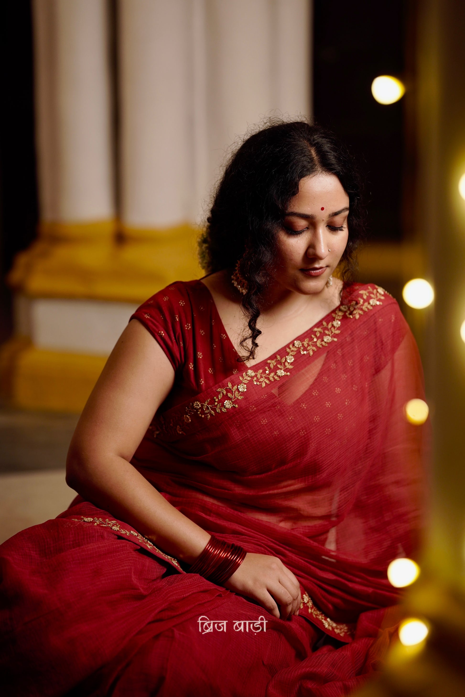 Jamuna handwoven deep-red colour Kota Doria saree with embroidered border and handmade thread tassel with ghungroo detailing on palla