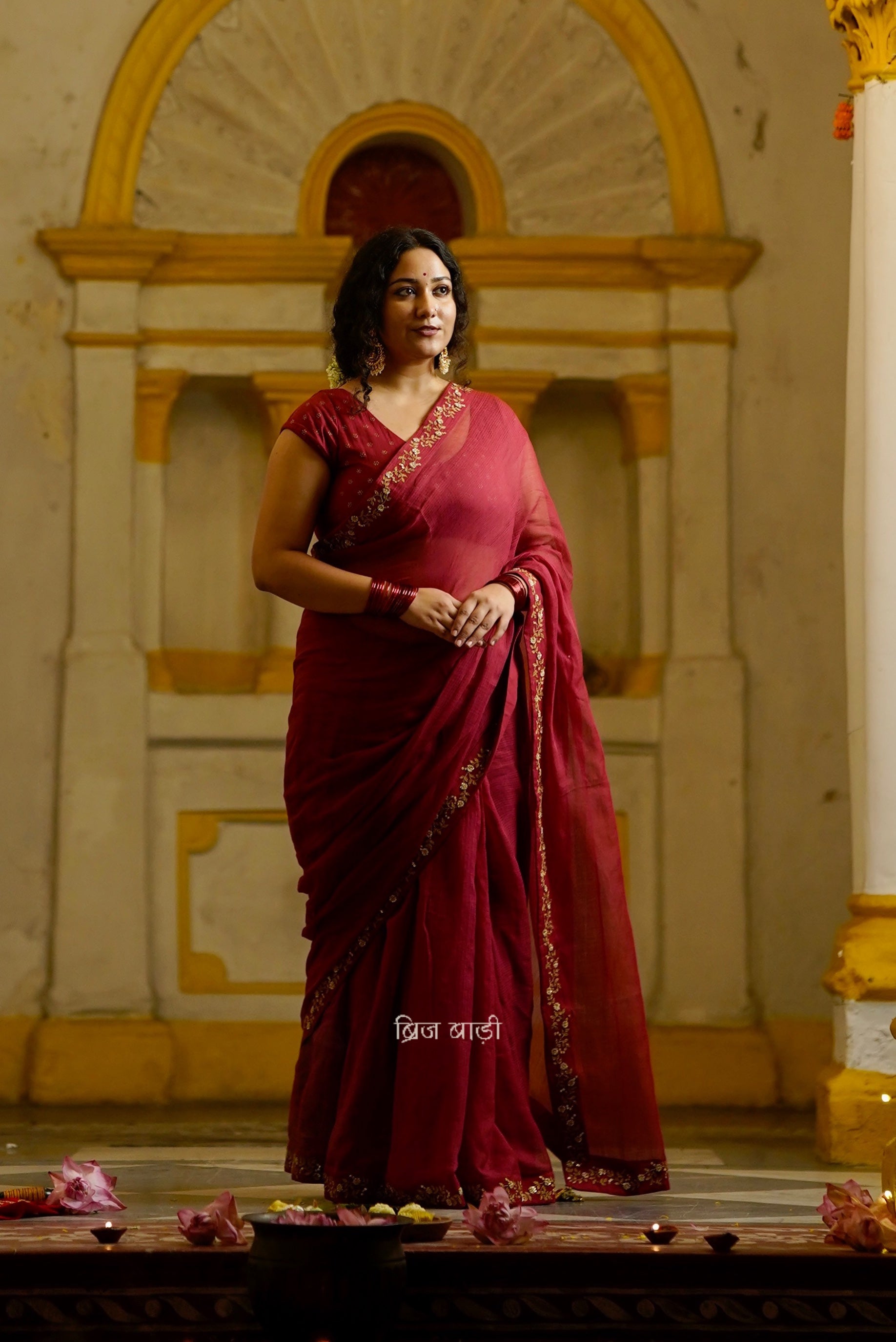 Jamuna handwoven deep-red colour Kota Doria saree with embroidered border and handmade thread tassel with ghungroo detailing on palla