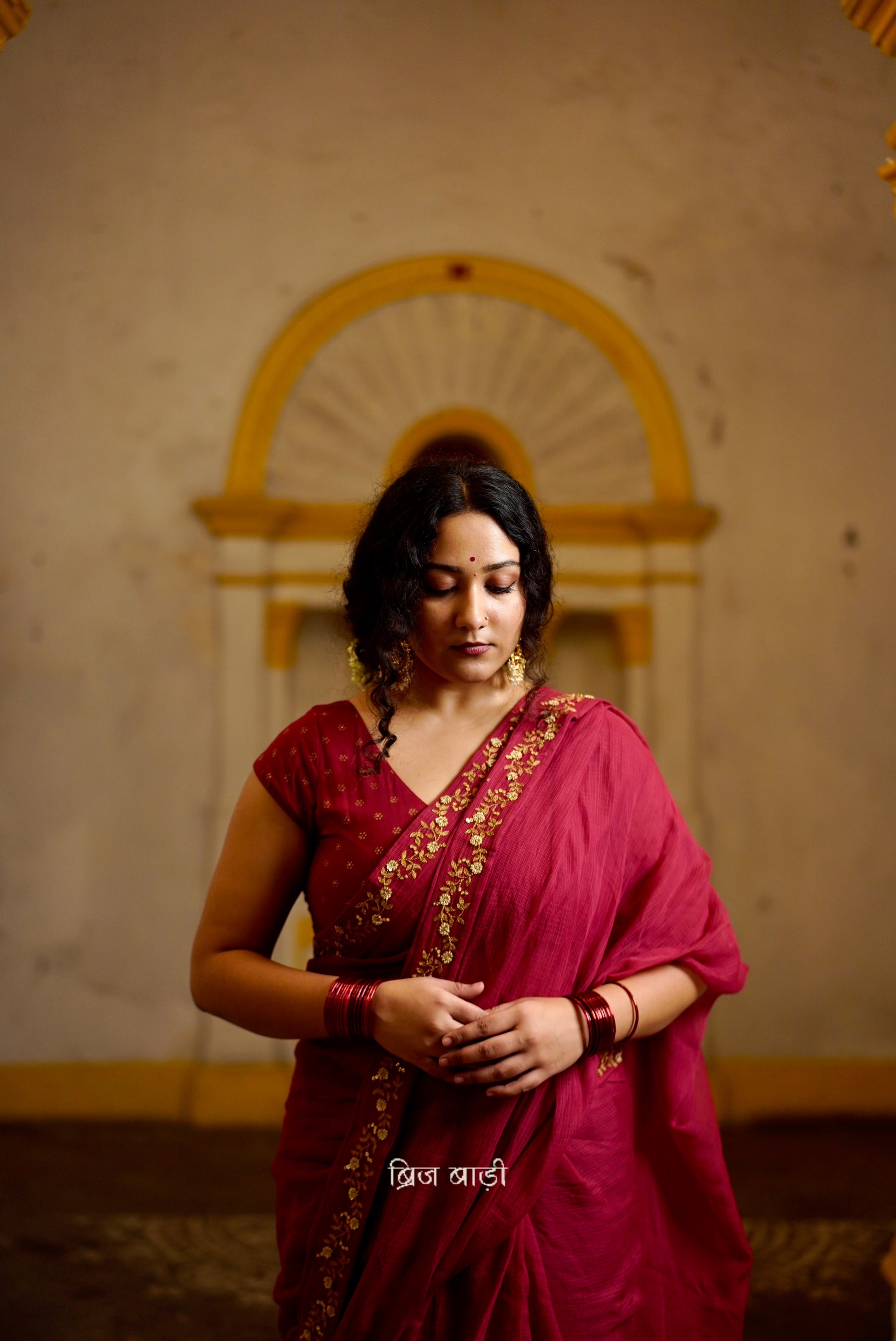 Jamuna handwoven deep-red colour Kota Doria saree with embroidered border and handmade thread tassel with ghungroo detailing on palla