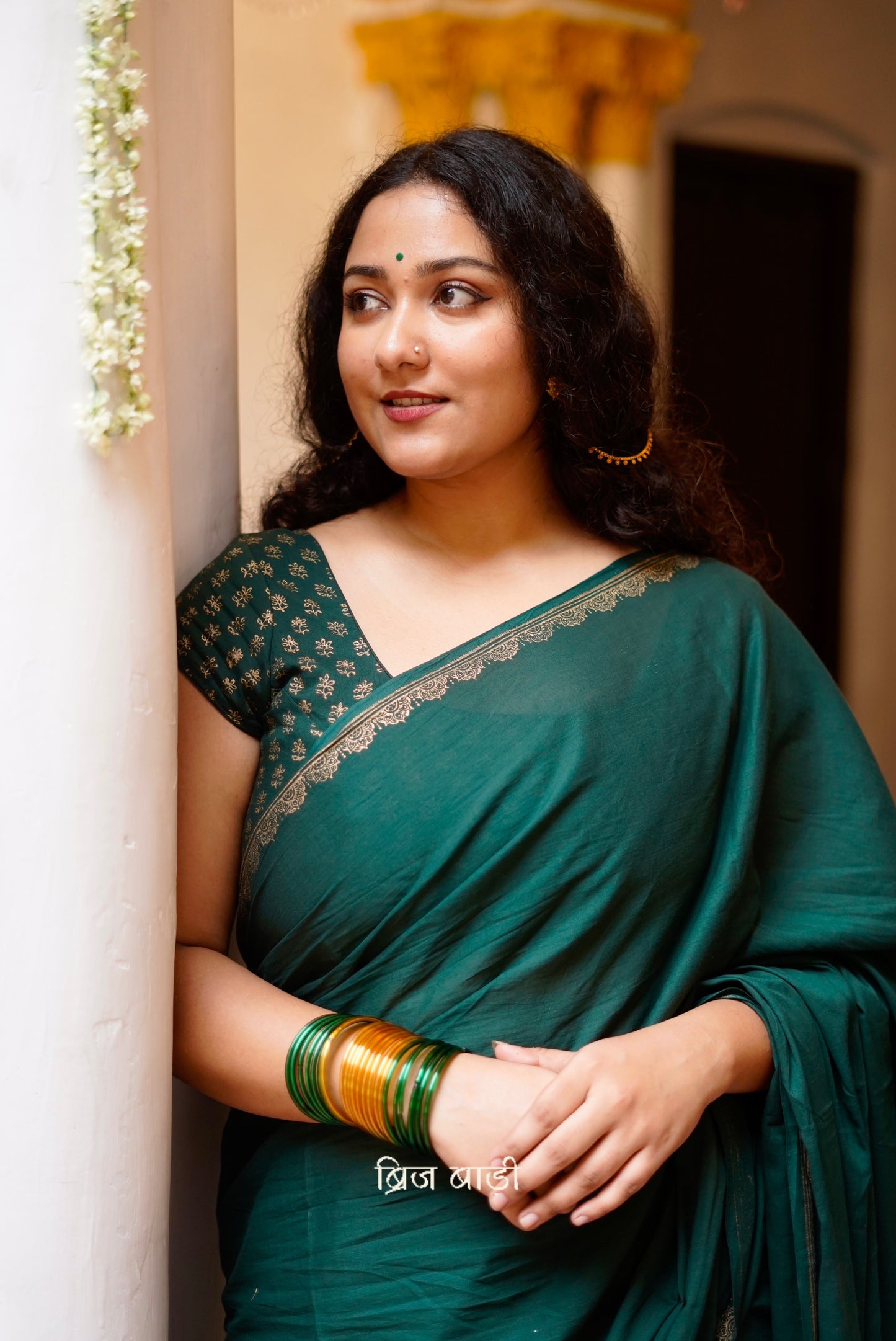 Narmada deep green cotton saree with hand block-printed gold border with thread tassel detailing on pallu