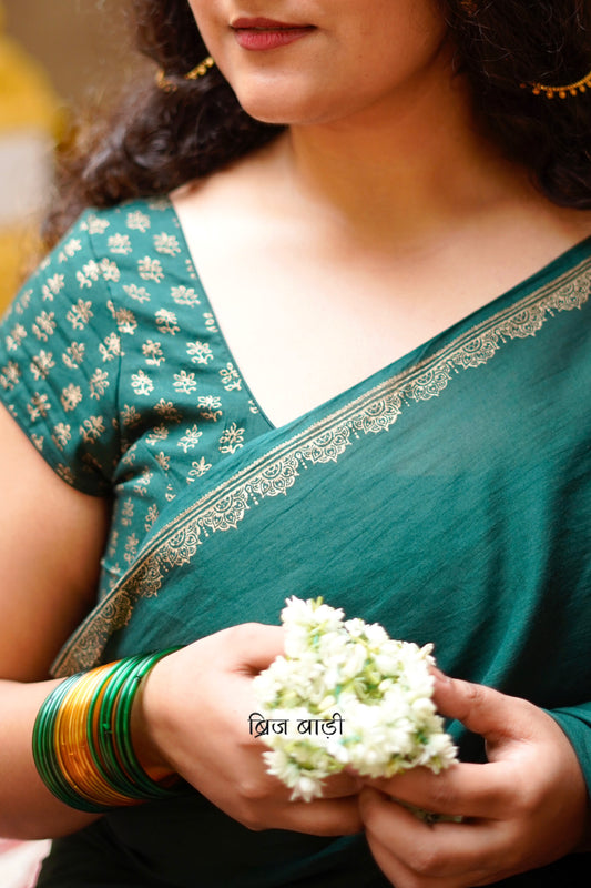 Narmada deep green cotton saree with hand block-printed gold border with thread tassel detailing on pallu