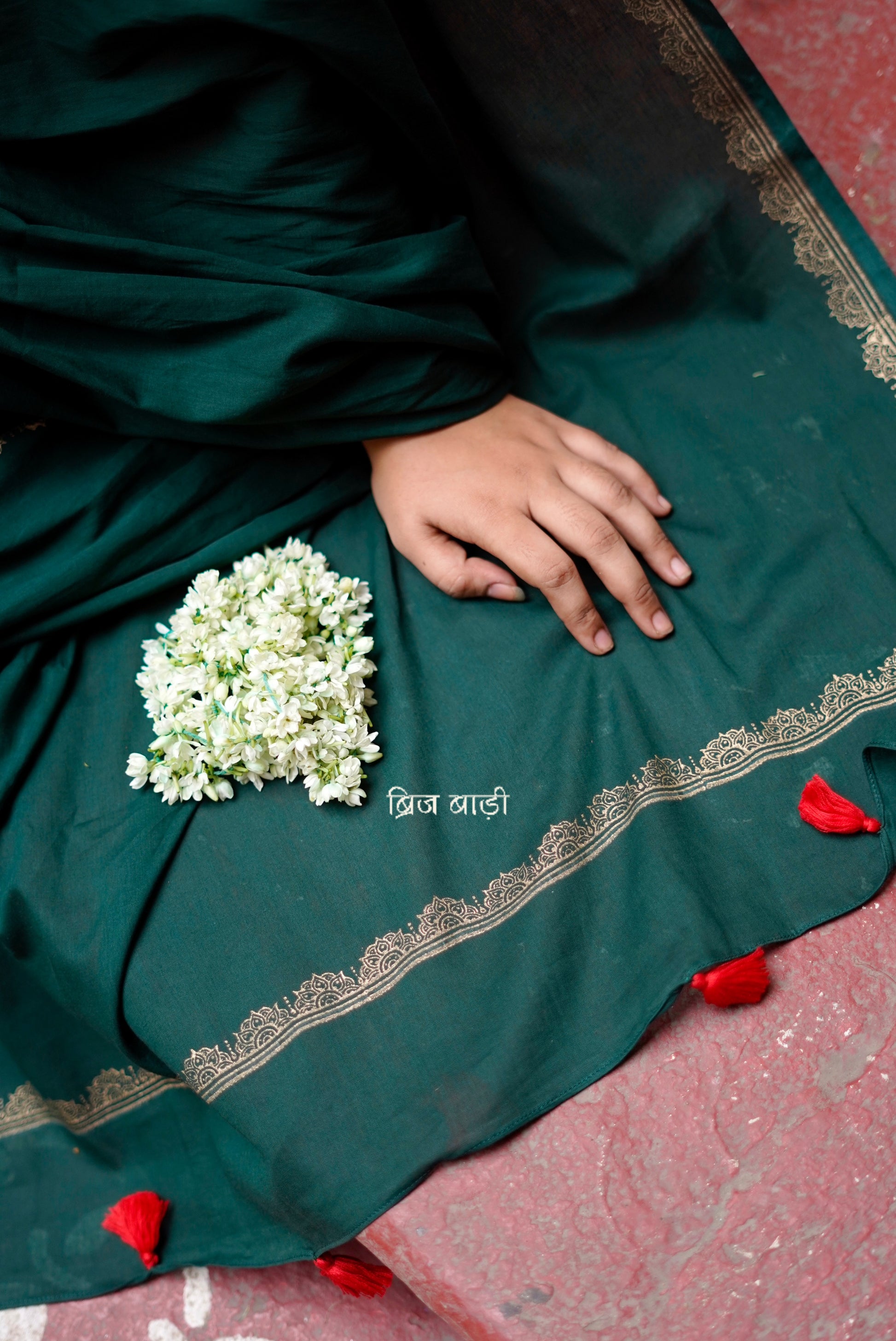 Narmada deep green cotton saree with hand block-printed gold border with thread tassel detailing on pallu