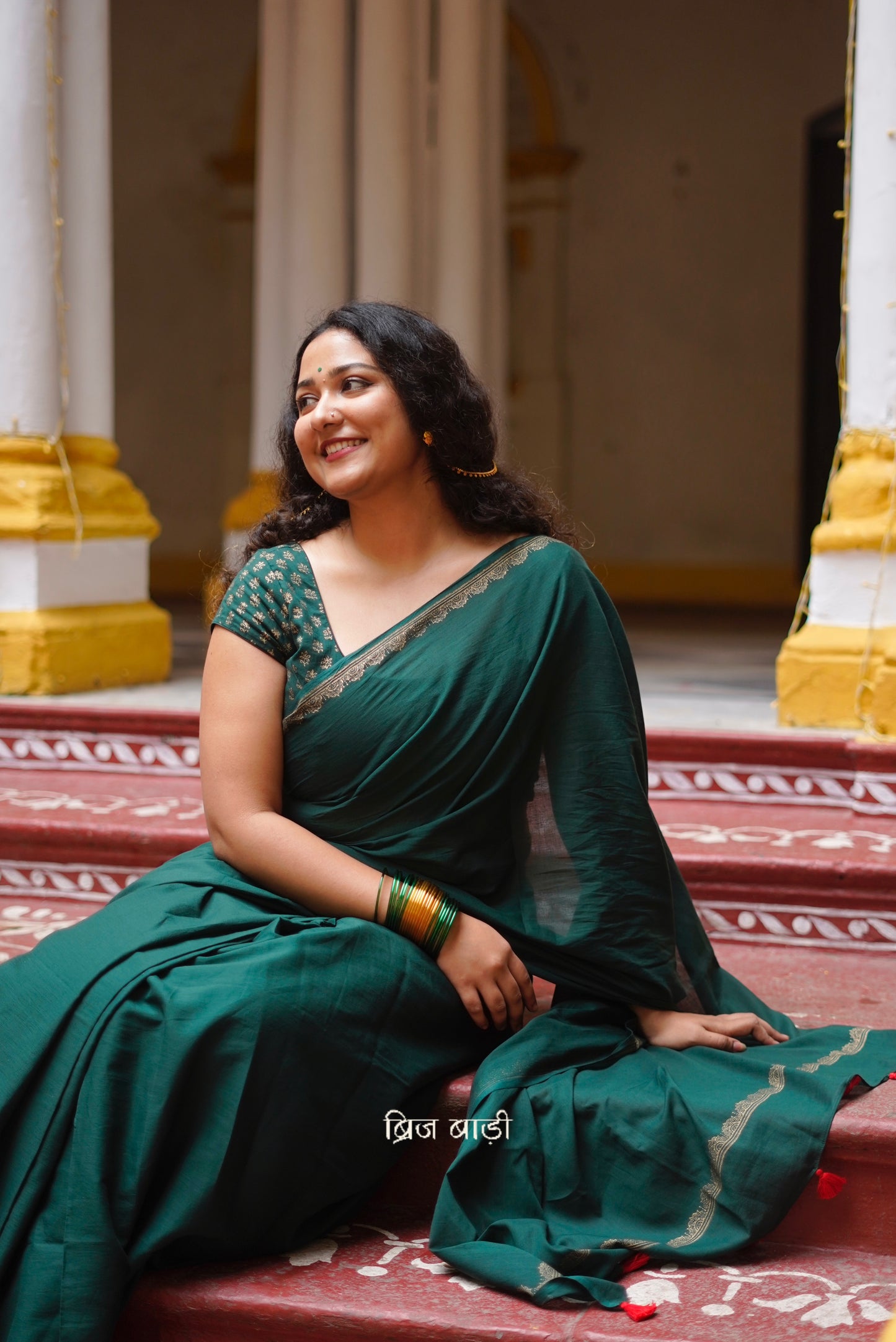 Narmada deep green cotton saree with hand block-printed gold border with thread tassel detailing on pallu