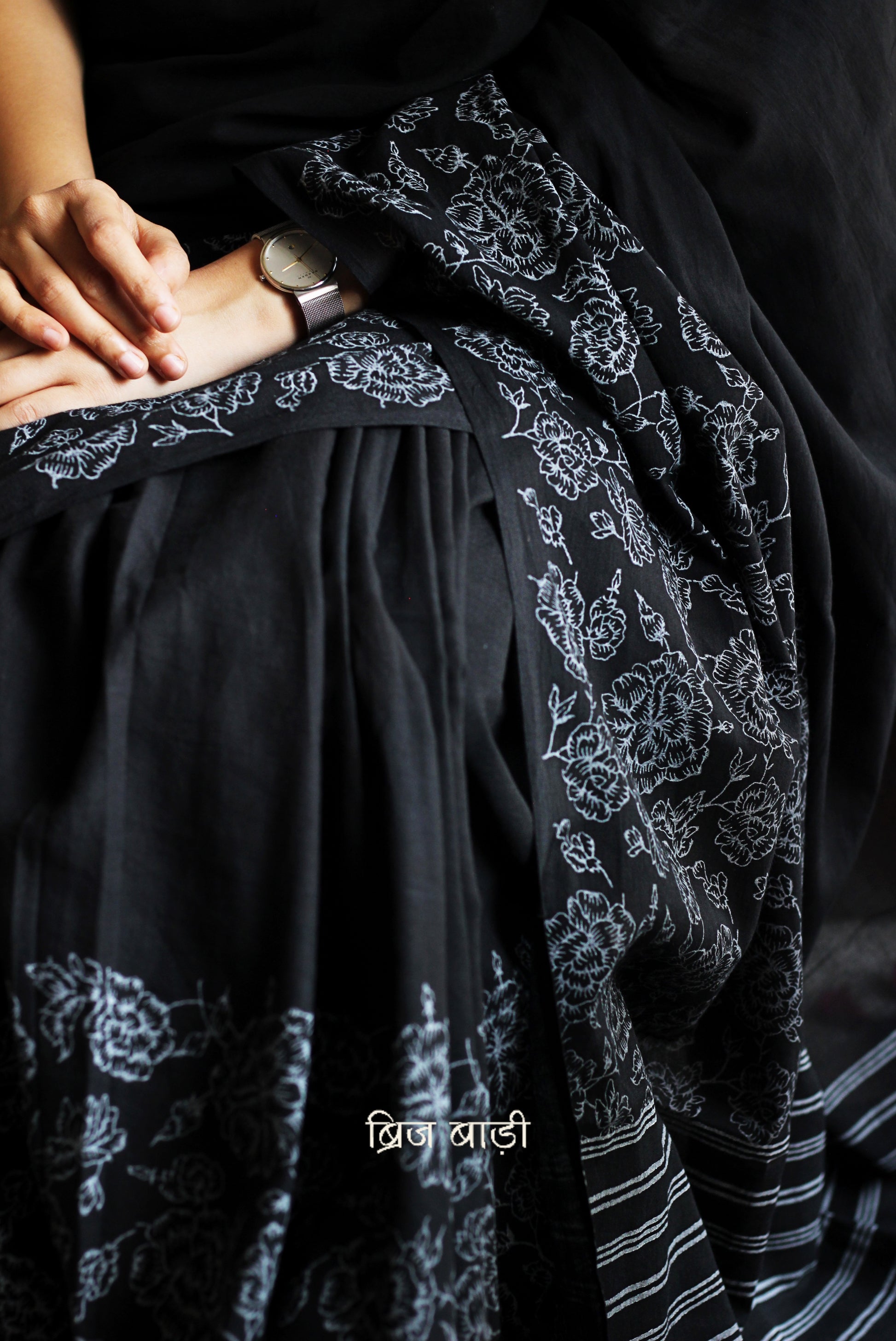 Black soft and light-weight cotton saree by Brij Bari, hand block printed with a graceful rose pattern on the skirt and contrasting bold stripes on the pallu. This versatile, breathable saree is designed for everyday ease — lightweight, elegant, and comfortable, perfect for casual outings & office wear. Finished with charming pink handmade thread tassels on the pallu. Comes with a free hand block printed blouse piece designed to compliment the sare’s floral and striped patterns. Free shipping pan India.