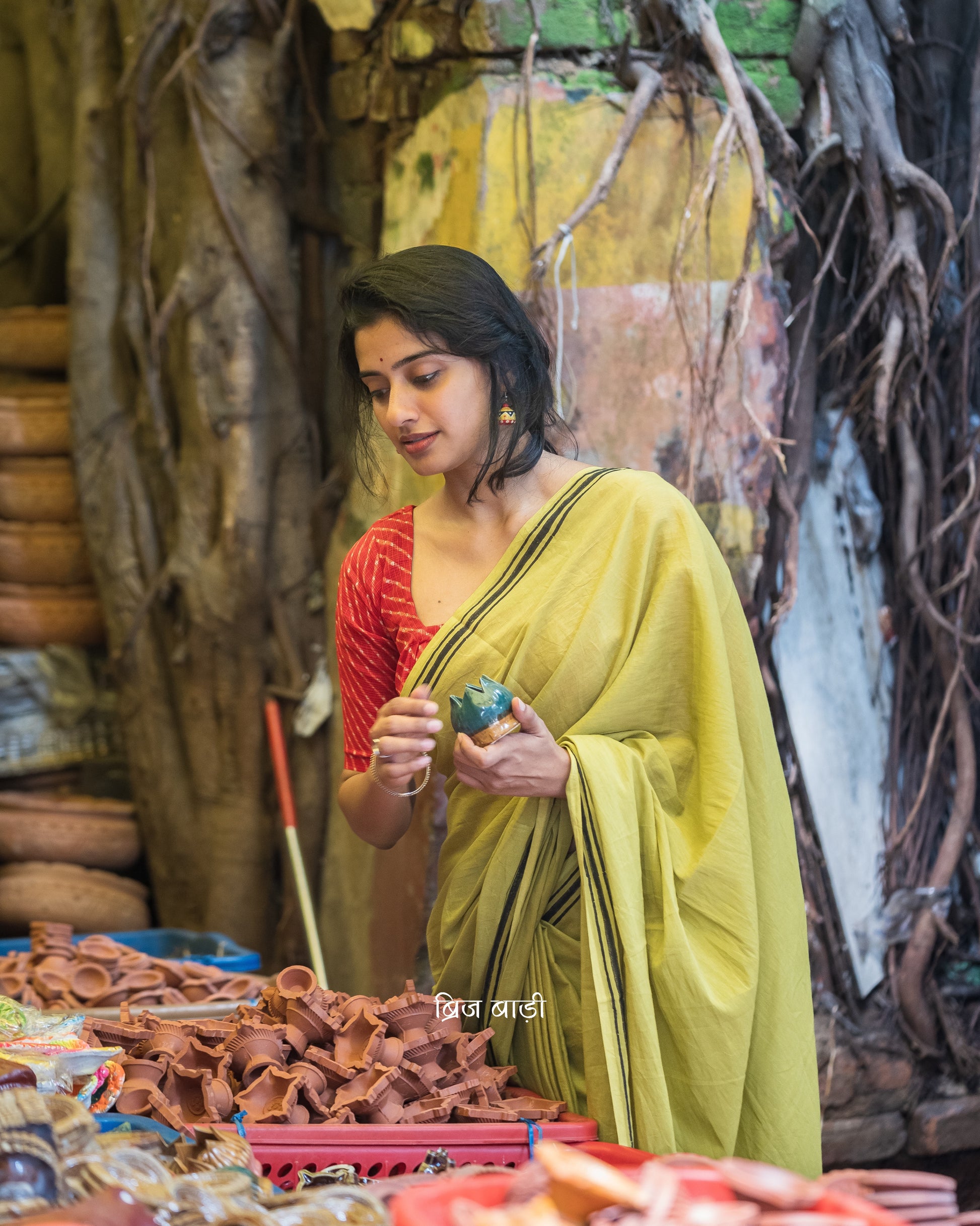 Renowned Social Media Influencer and Actor Sushmita Bhat in our Phalguni saree. Light green soft and light-weight cotton saree by Brij Bari, crafted with a simple yet elegant black hand block printed stripe border. The saree is adorned with red handmade thread tassels on the pallu, adding a vibrant touch. It comes with a free matching block printed blouse piece, offering a complete handcrafted look. Available in 2 colours, designed for all-day comfort and style, perfect for casual and everyday wear. 