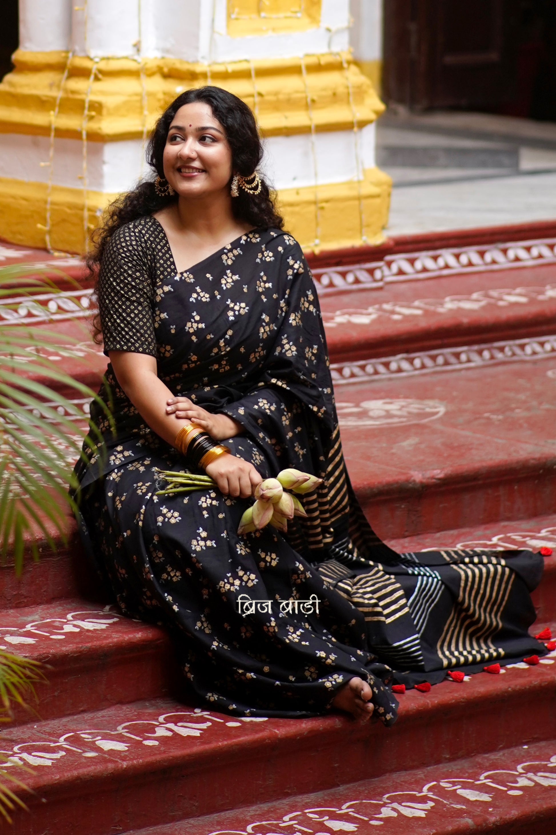 Tapti black cotton saree with gold and silver hand block-printed floral motifs with handmade thread tassel detailing on palla. 