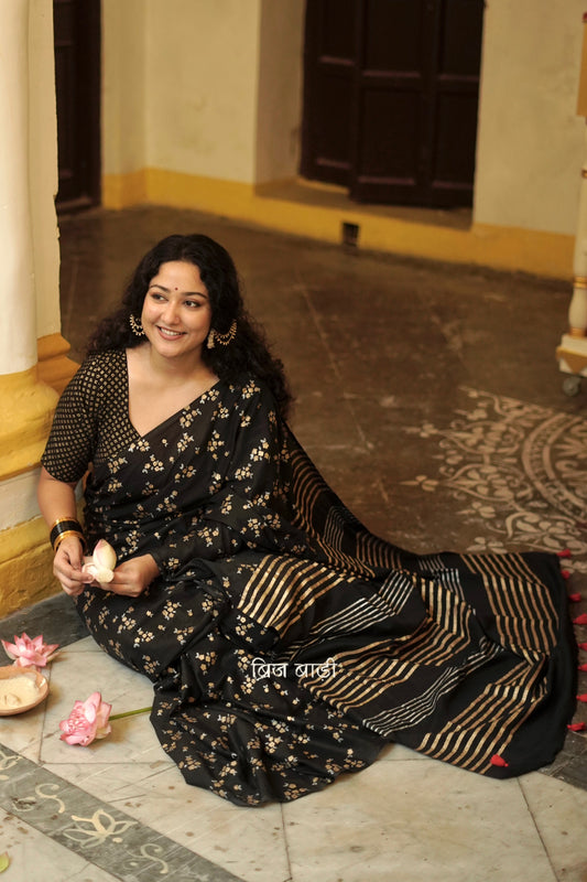 Tapti black cotton saree with gold and silver hand block-printed floral motifs with handmade thread tassel detailing on palla. 
