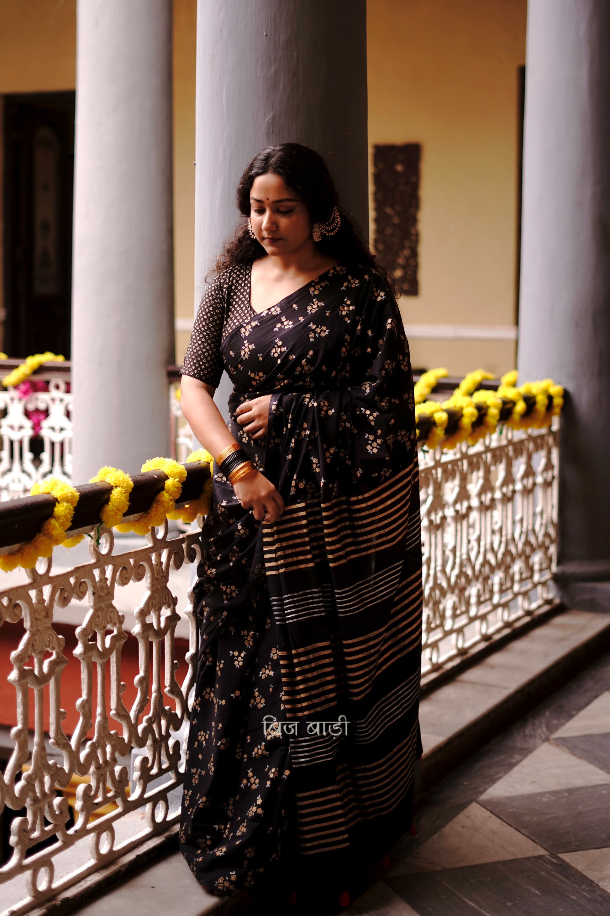 Tapti black cotton saree with gold and silver hand block-printed floral motifs with handmade thread tassel detailing on palla. 