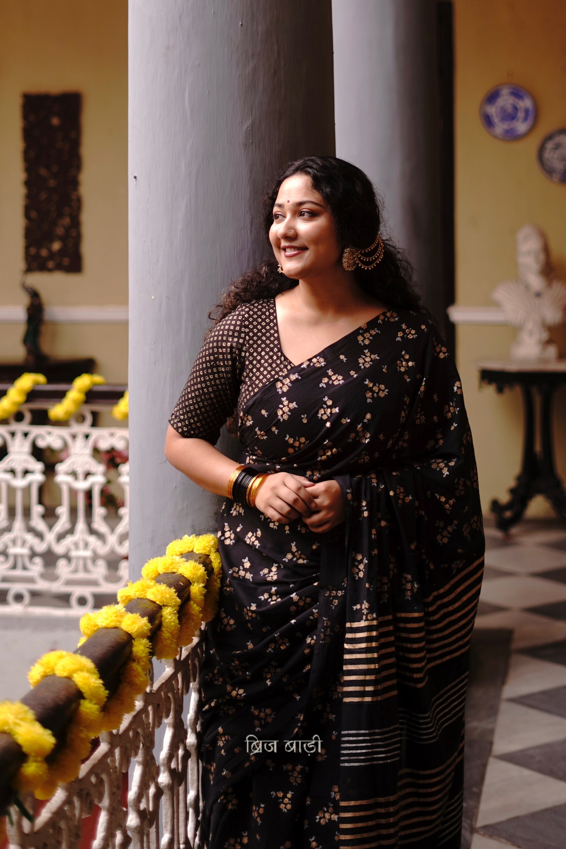 Tapti black cotton saree with gold and silver hand block-printed floral motifs with handmade thread tassel detailing on palla. 