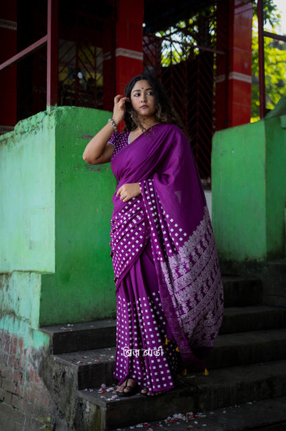 Purple soft cotton hand block printed saree with intricate patterns, offering a blend of elegance and comfort, perfect for both casual and festive occasions.