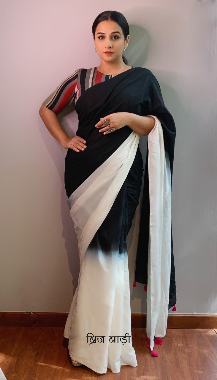 Renowned Film Actress Vidya Balan wearing Chandni Raat cotton saree by Brij Bari. This saree has been hand dyed in subtle blend of tones adds fluidity and grace to the drape. The pallu is adorned with handcrafted pink thread tassels, lending an artisanal touch. It comes with a free hand block printed blouse piece that complements the saree’s minimal yet striking aesthetic. Available in 8 beautiful colour options
